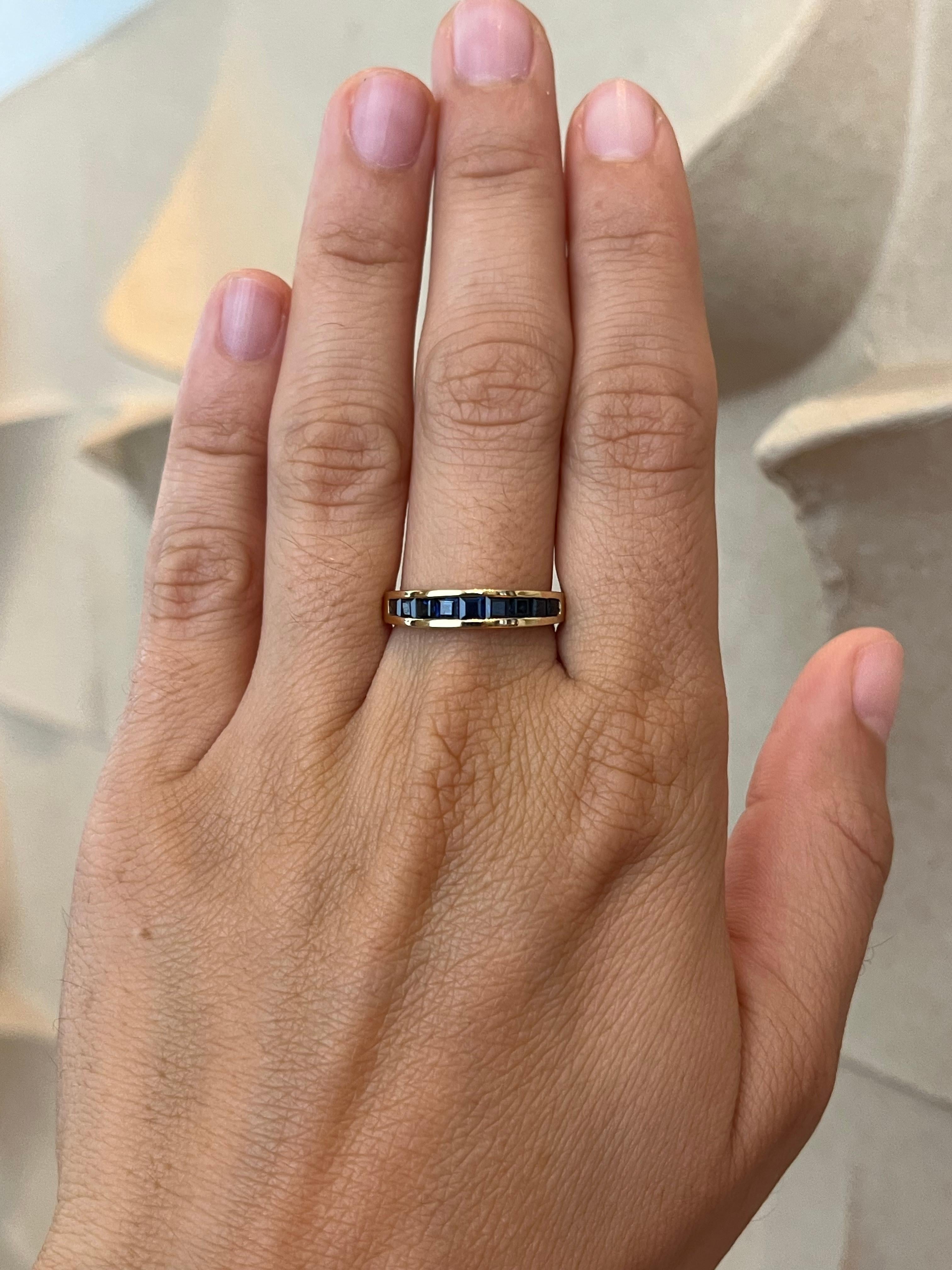 From the Bracken Jewelers estate fine jewelry collection in Santa Monica, California. Nine square cut blue sapphires are channel set in this 14K yellow gold wedding band. The tapered design makes for a comfortable fit.

- 9 square cut blue sapphires