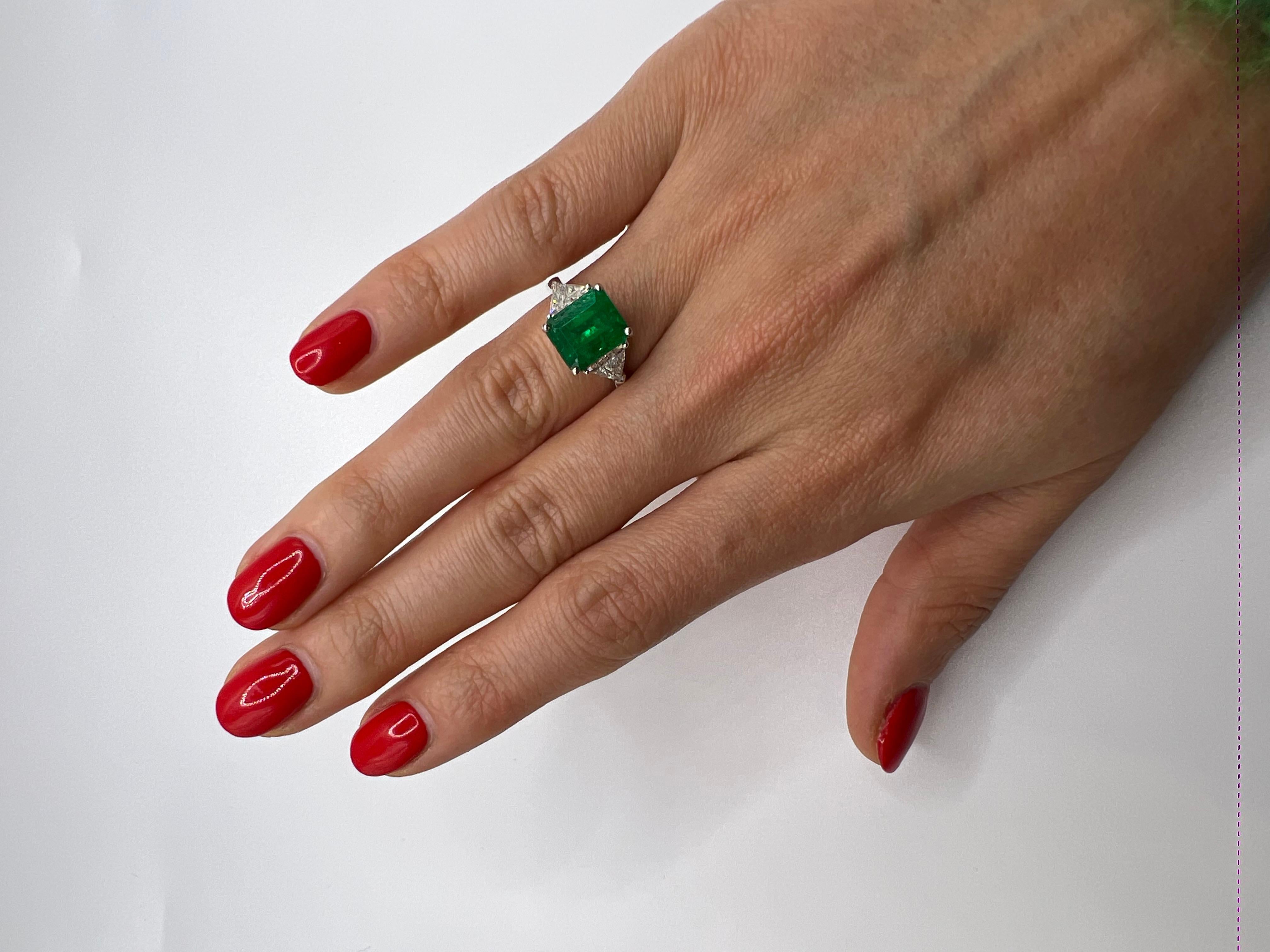 This is a Gorgeous Colombian Emerald and Trilliant Cut Diamond. set with a square cut Colombian emerald weighting 3.20 carats , within two Trilliant Cut Diamonds in total weight 1.60 ( 0.80 each ) ,approximately F/G color - clarity VVS/VS . set in