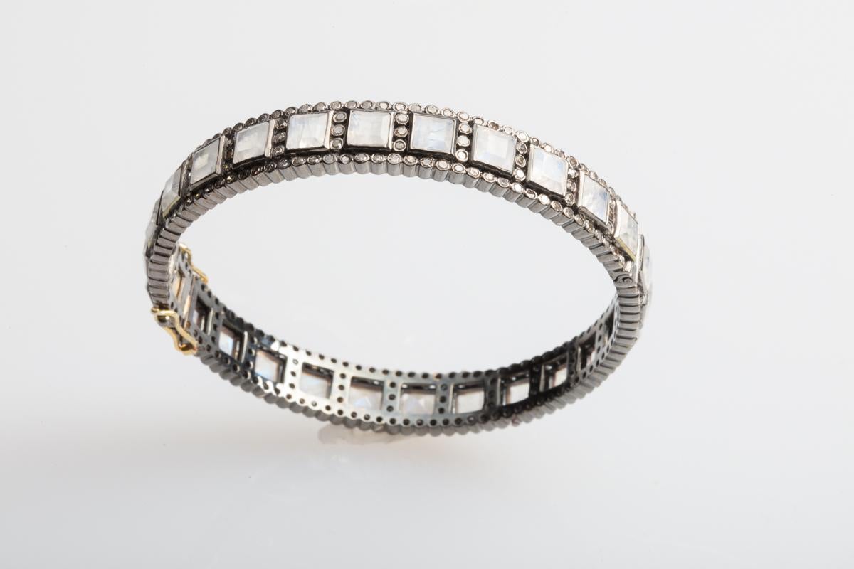 Beautiful and fiery sqare-cut faceted moonstone bracelet bordered with pave` set diamonds.  Set in an oxidized sterling silver, diamond push clasp with two safeties on the side.  Moonstone weight is 16.90 carats and diamonds are 3.50 carats.  This