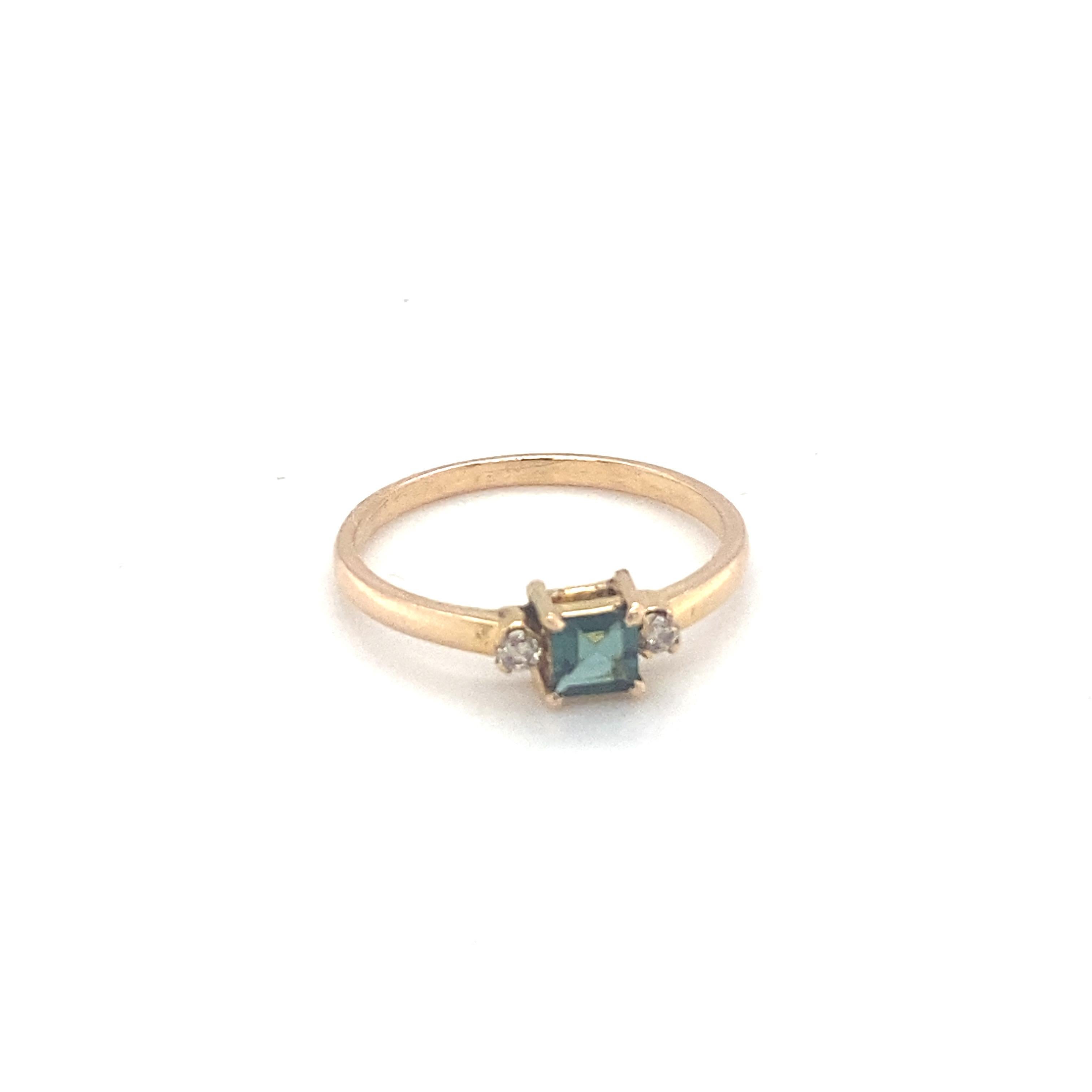 Square cut deep green tourmaline ring is mounted in 14K yellow gold. Beautifully hand crafted ring with accent diamonds on east west makes it an elegant piece of jewelry. Carefully chosen gem stone is hand cut and polished. One of a kind ring to