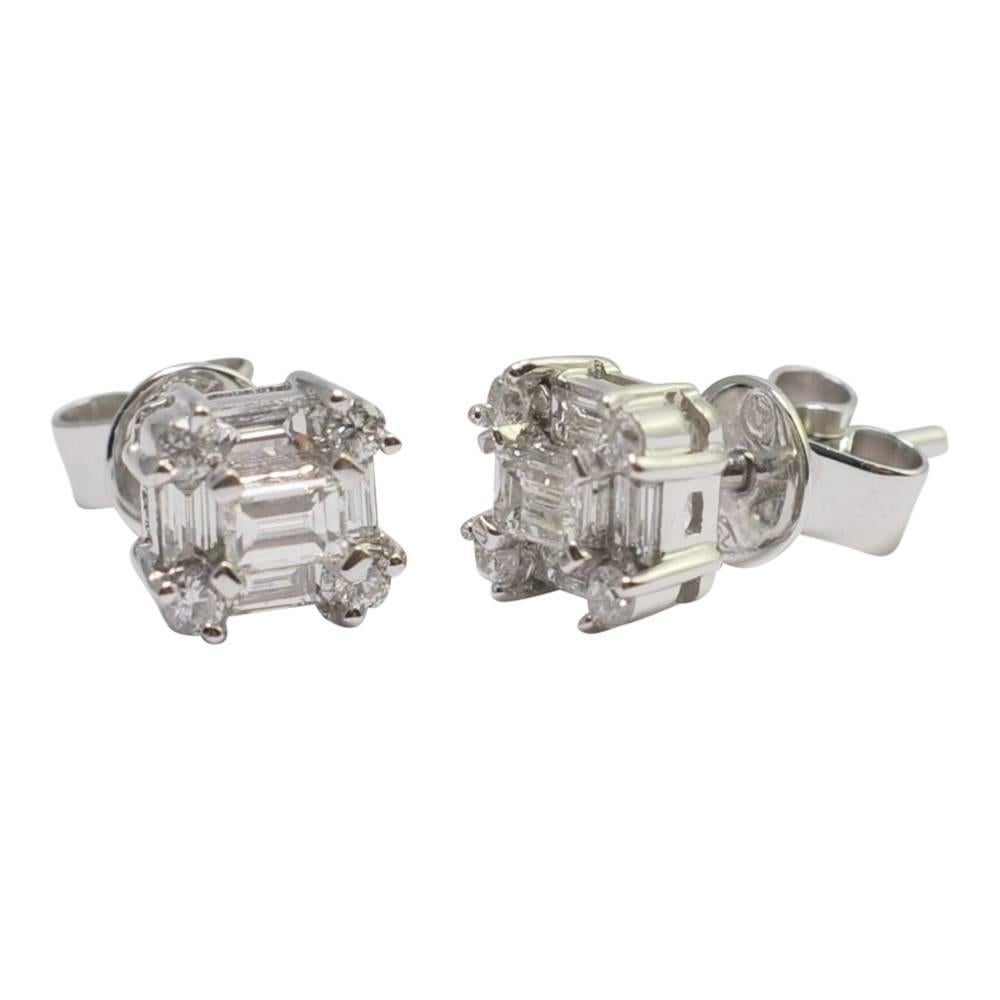 Square diamond cluster earrings; a change from the classic studs or round cluster earrings, these pretty earrings are composed of a central baguette diamond surrounded by a further 4 baguettes and 4 brilliant cut diamonds in the corners totalling