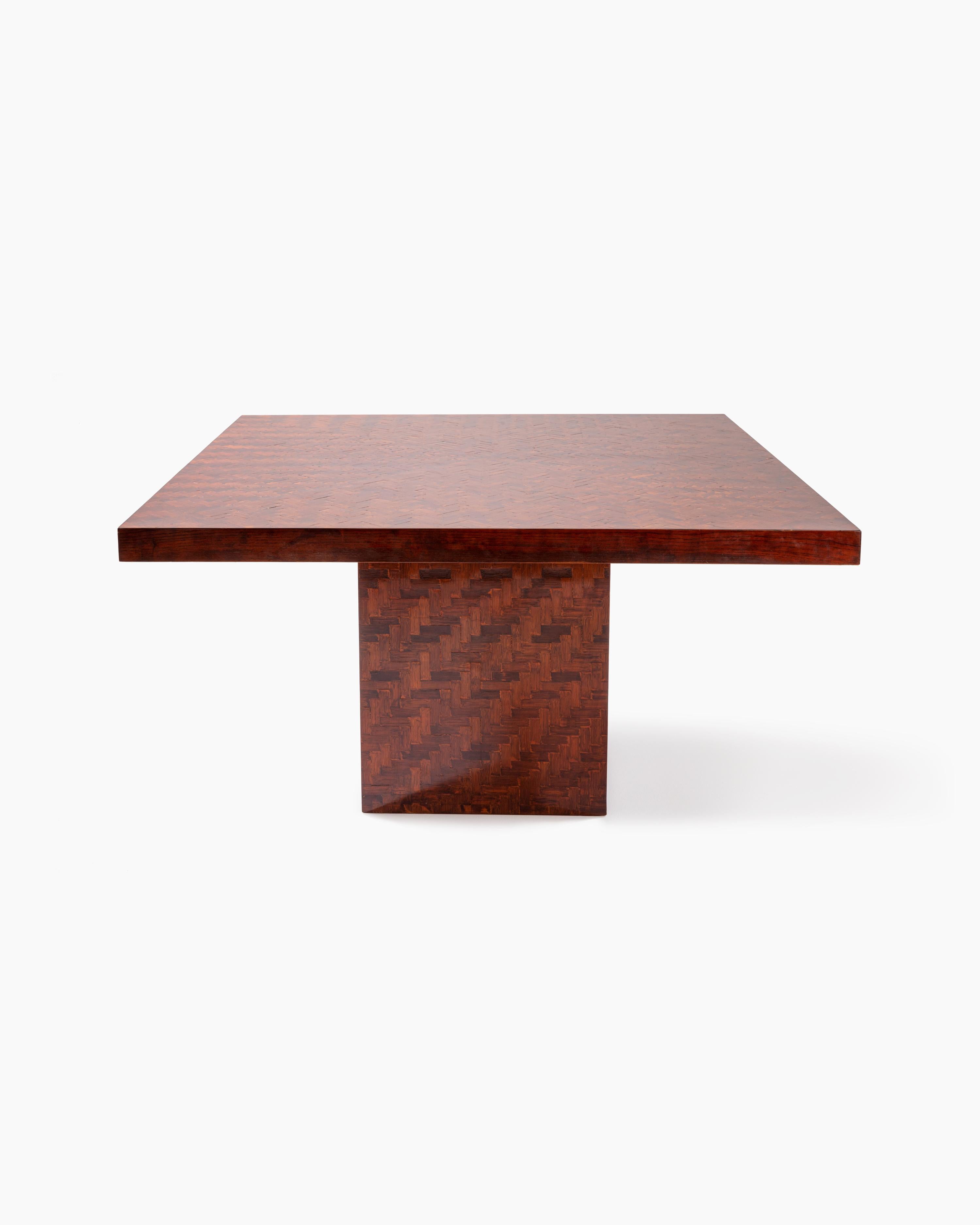 Produced by Mobilificio Fratelli Turri, founded by Pietro Turri in 1925, this square dining table honors the company’s value of craftsmanship and luxury in interior decorating, featuring Dyed Banana Leaf Weaving ontop of Wood finished with Varnish.