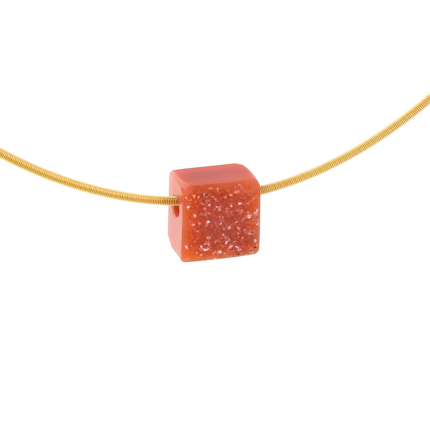 This necklace is made from a soft-orange Carnelian Drusy carved into a square shape and hung on an 18 Karat Yellow Gold circular necklace. This is quite an opaque specimen of Carnelian. A contemporary piece: simple, uncluttered and