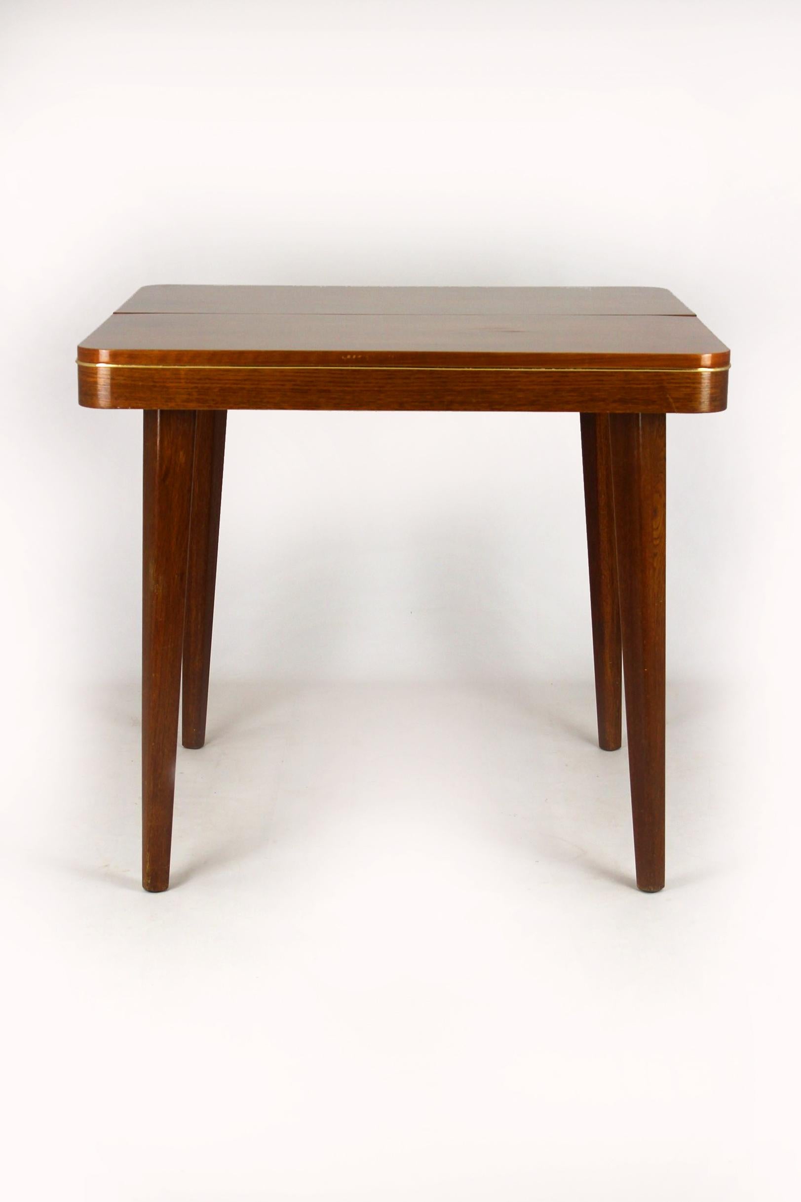 Square folding dining table from Jitona,
produced in the mid-1960s.
The table is preserved in its original, good condition.
Legs can be simply removed for transport or storage.
The table measures 128cm wide when fully extended.