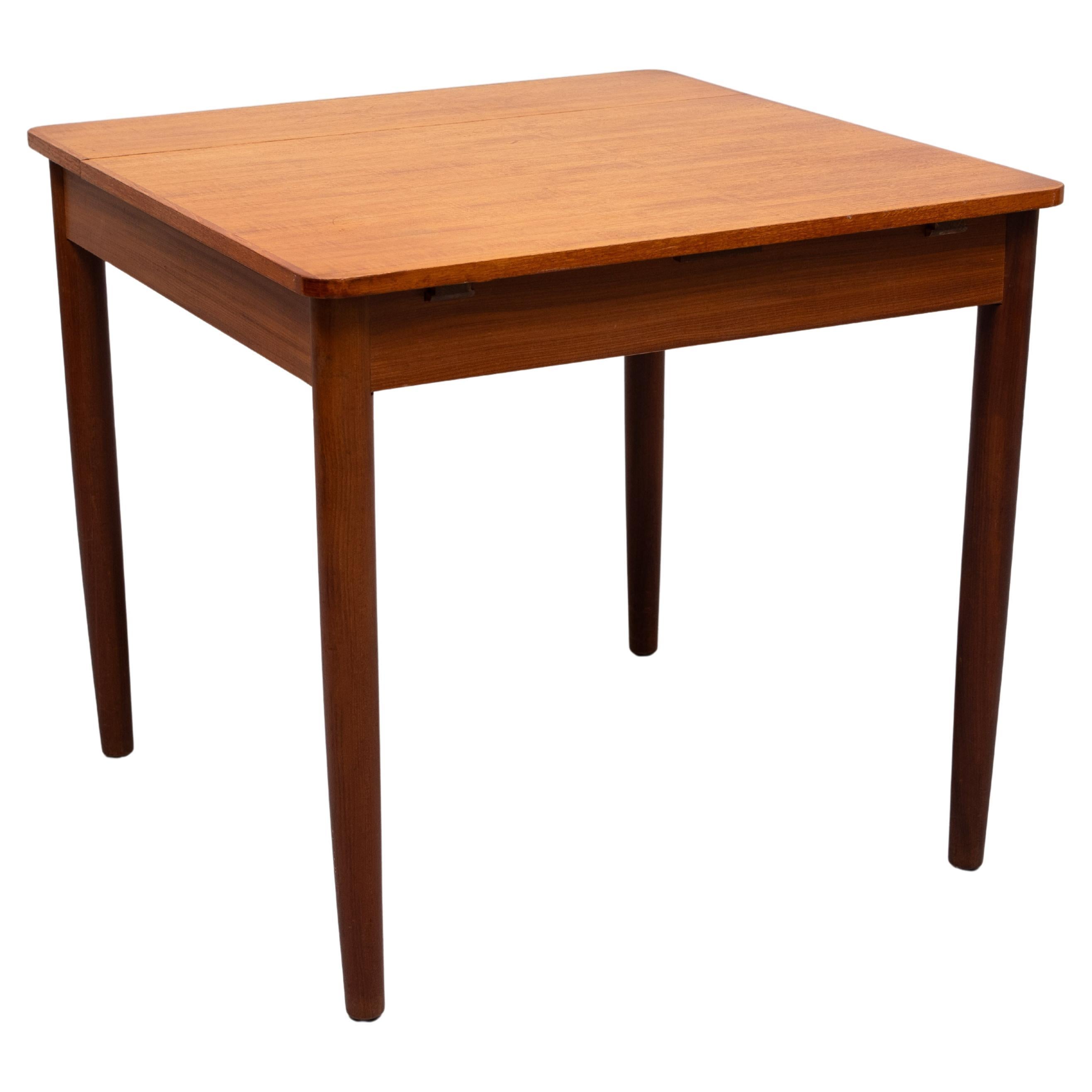 Very nice square Teak dining table ,extendable by a folding 
our extension . From  80 cm to 120 cm . Nice warm Teak color .
no discoloration . Ideal dining table for smaller houses . 
The legs are detached .