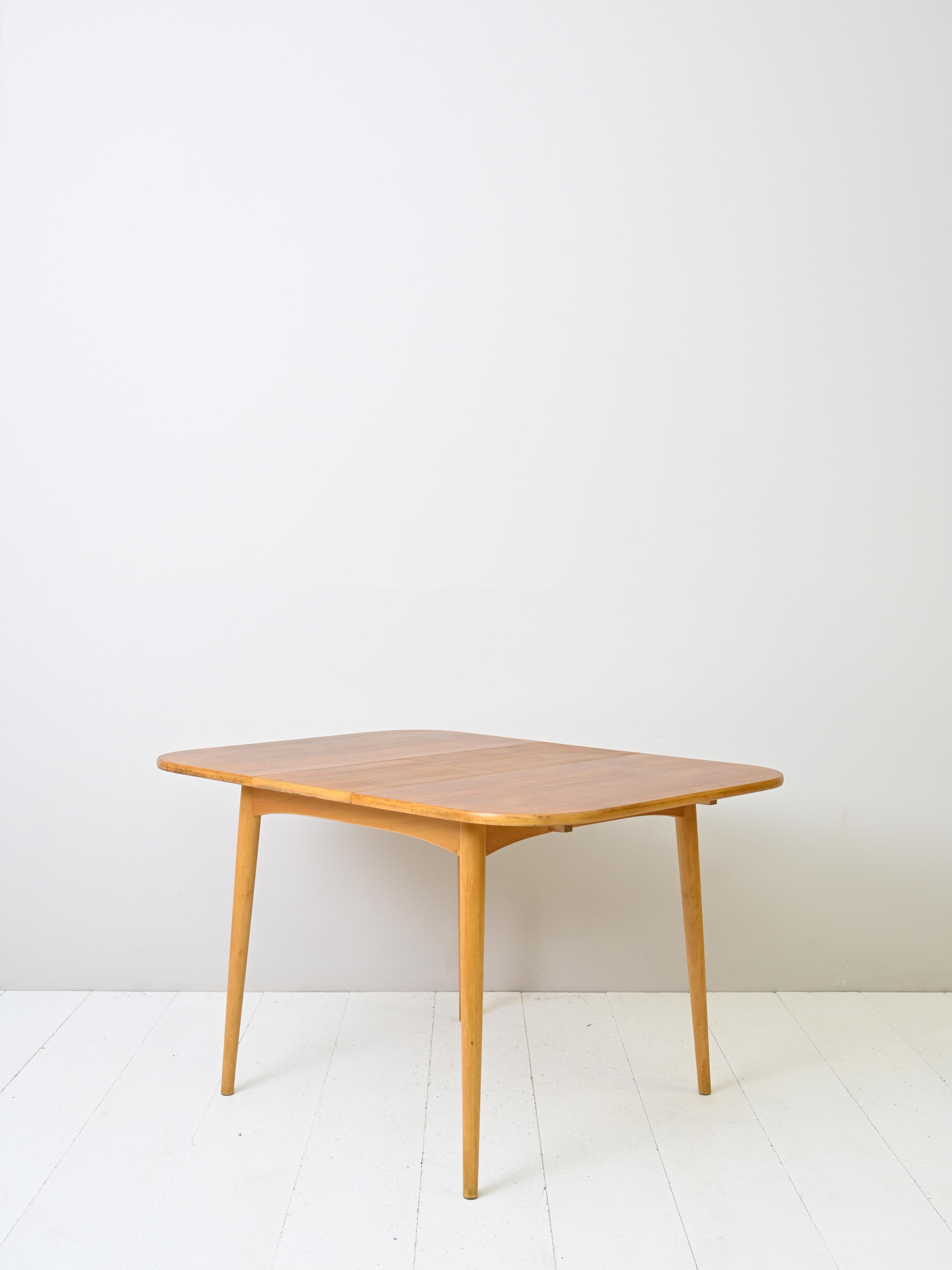 Square extendable teak table made in Scandinavia in the 1960s.

Beautiful and functional square table that can be extended with a center board.

The table with rounded corners features a teak wood top.

TABLE DIMENSIONS CLOSED 90CM 
TABLE