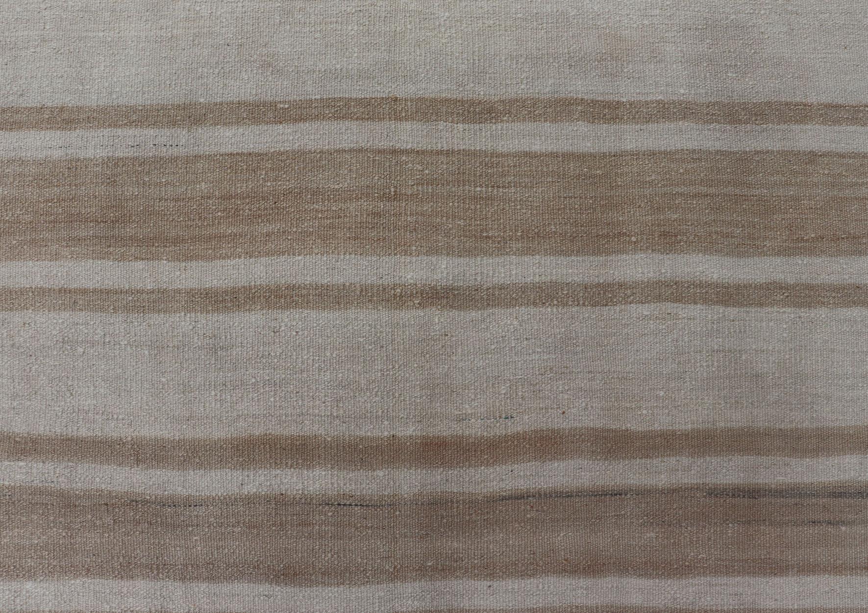 Flat-Weave Kilim vintage rug from Turkey with horizontal brown and taupe stripes on a cream background. Keivan Woven Arts /  rug EN-179787, country of origin / type: Turkey / Kilim, circa 1950
Measures:6'2 x 6'6 
This vintage flat-woven Kilim