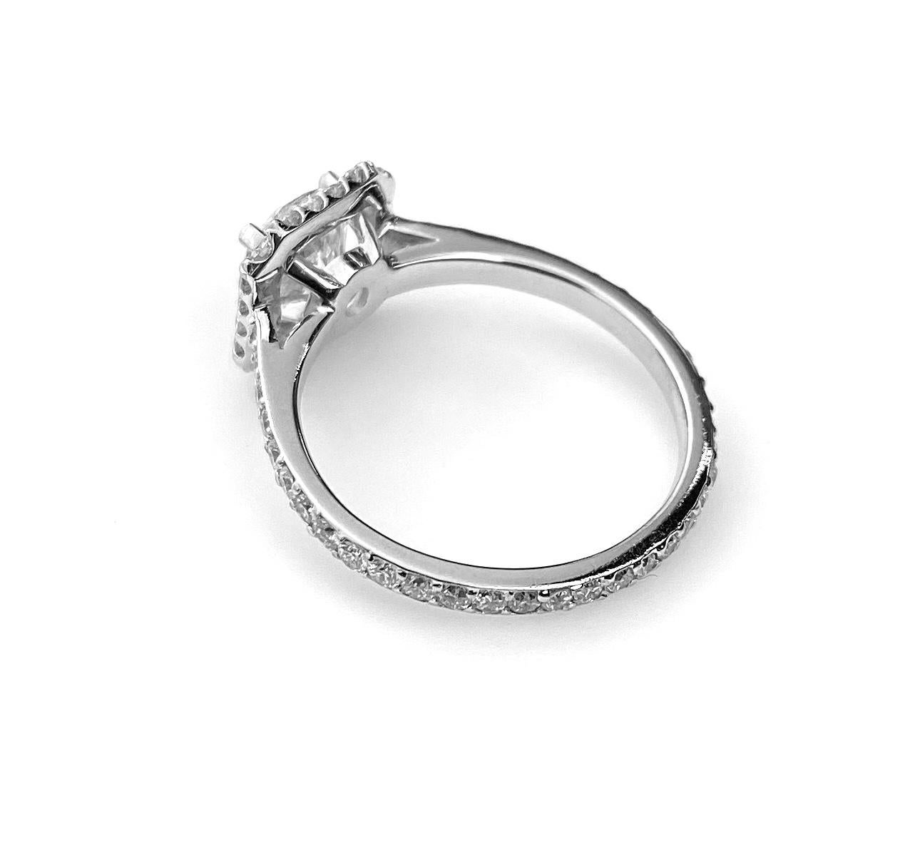 Square halo engagement ring in 18k white gold with 0.99ct round brilliant cut center diamond, G colour and VS2 clarity. Surrounded by a micro-set halo and band of 56 diamonds totaling 0.64ct. Current ring size 5 1/4. Complementary ring resizing up
