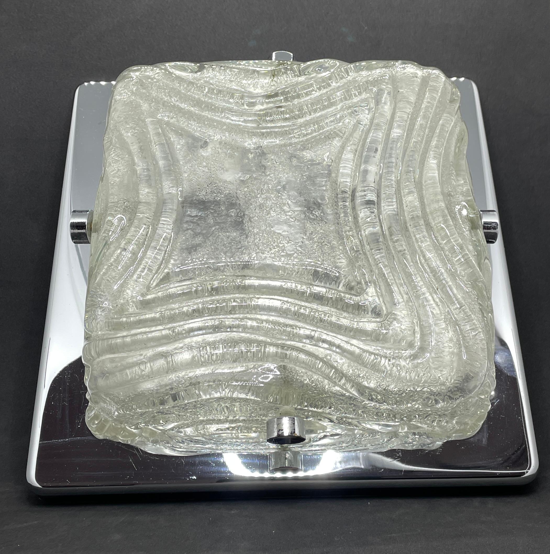 A stunning large textured glass flush mount attributed to Kalmar Leuchten. It has a very heavy ice glass on a metal chrome frame. The Fixture requires two European E14 / 110 Volt Candelabra bulbs, each bulb up to 40 watts.