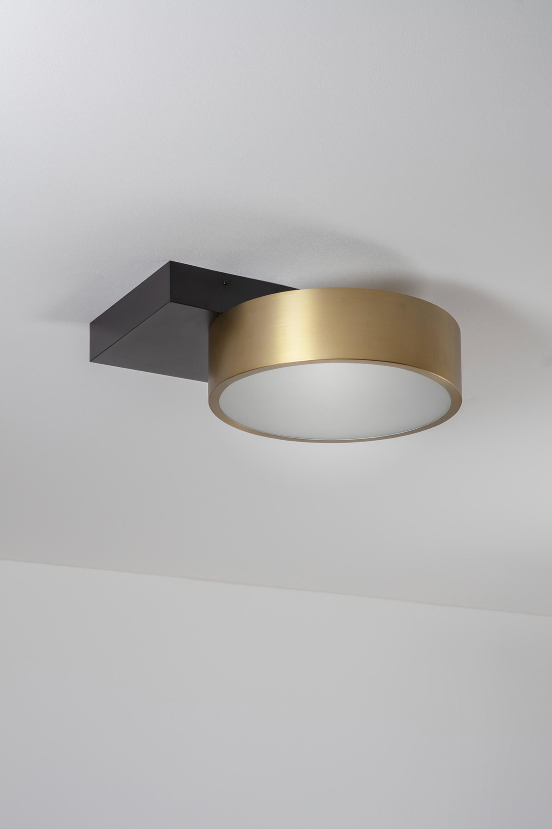 Square in Circle Ceiling Light by Square in Circle
Dimensions: D 43 x W 43 x H 16 cm
Materials:Brushed brass/Dark bronze/ white frosted glass
Other finishes available.

Simple, yet innovative, the round brushed brass ceiling light is attached to a