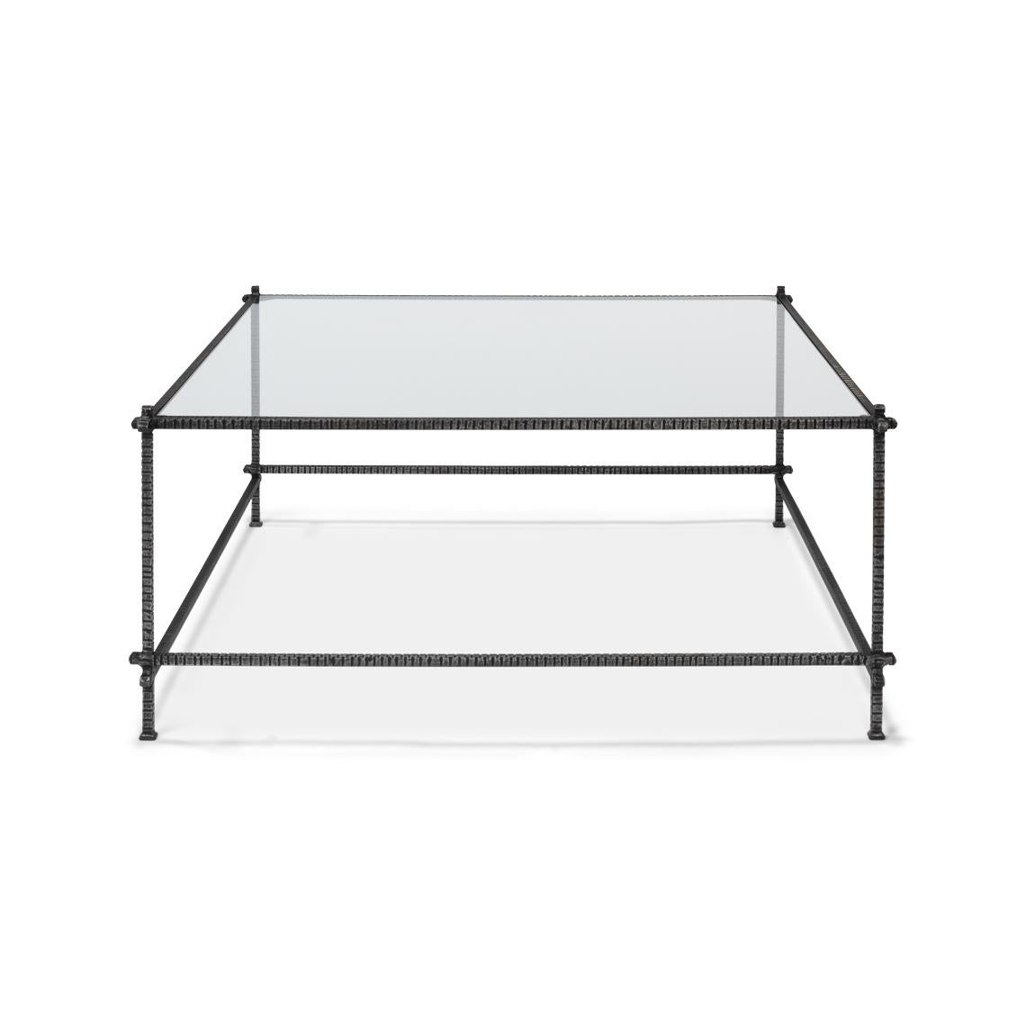 This coffee table strikes a perfect balance between modern design and functional artistry. The sleek, clear glass top is a canvas for your coffee table books, floral arrangements, or your favorite decorative pieces.

The frame, welded and hand-cut
