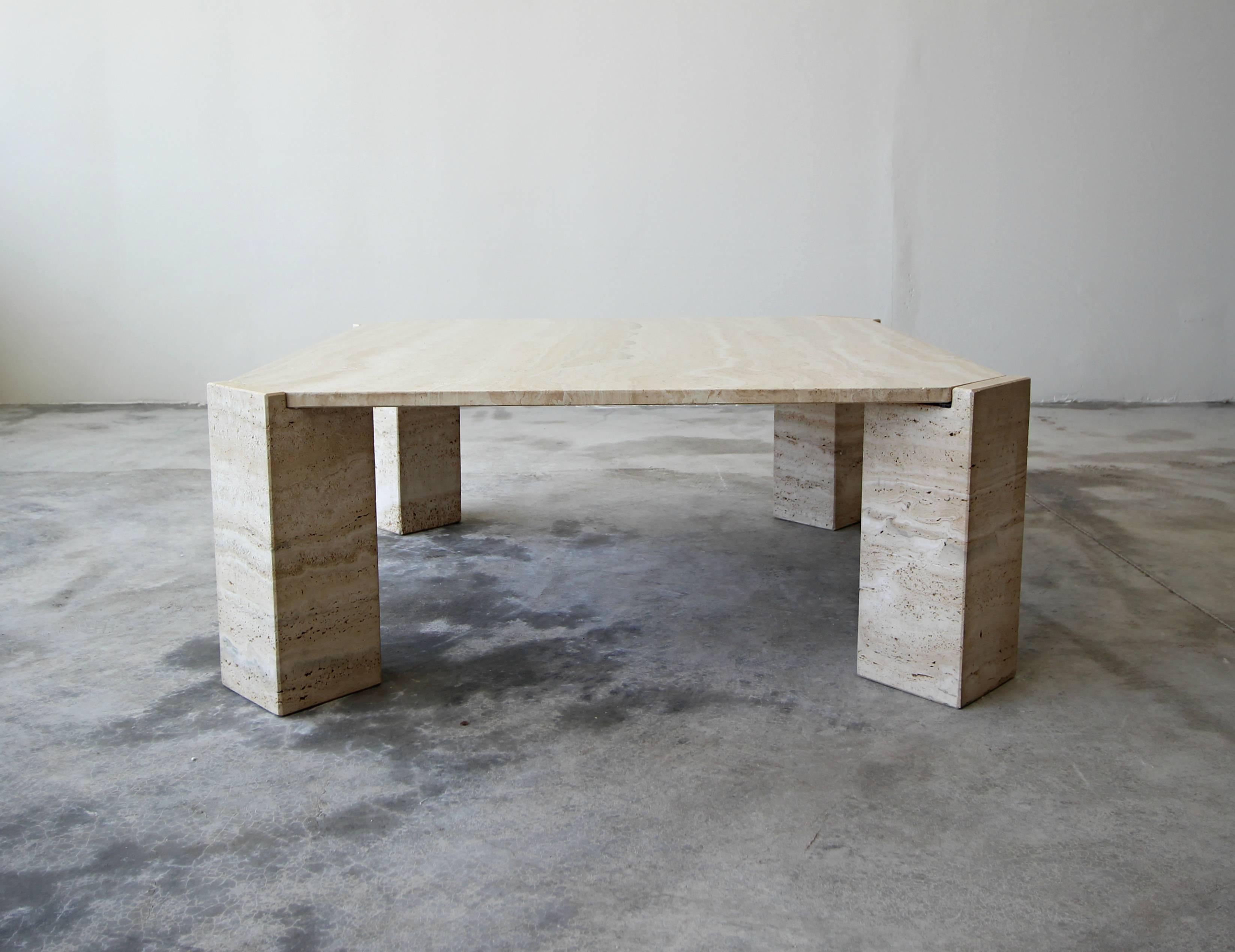 Solid travertine coffee table. Simple beautiful piece. Tabletop is square with four legs that are positioned on a diagonal. Legs are a honed finish and the top is a contrasting gloss.