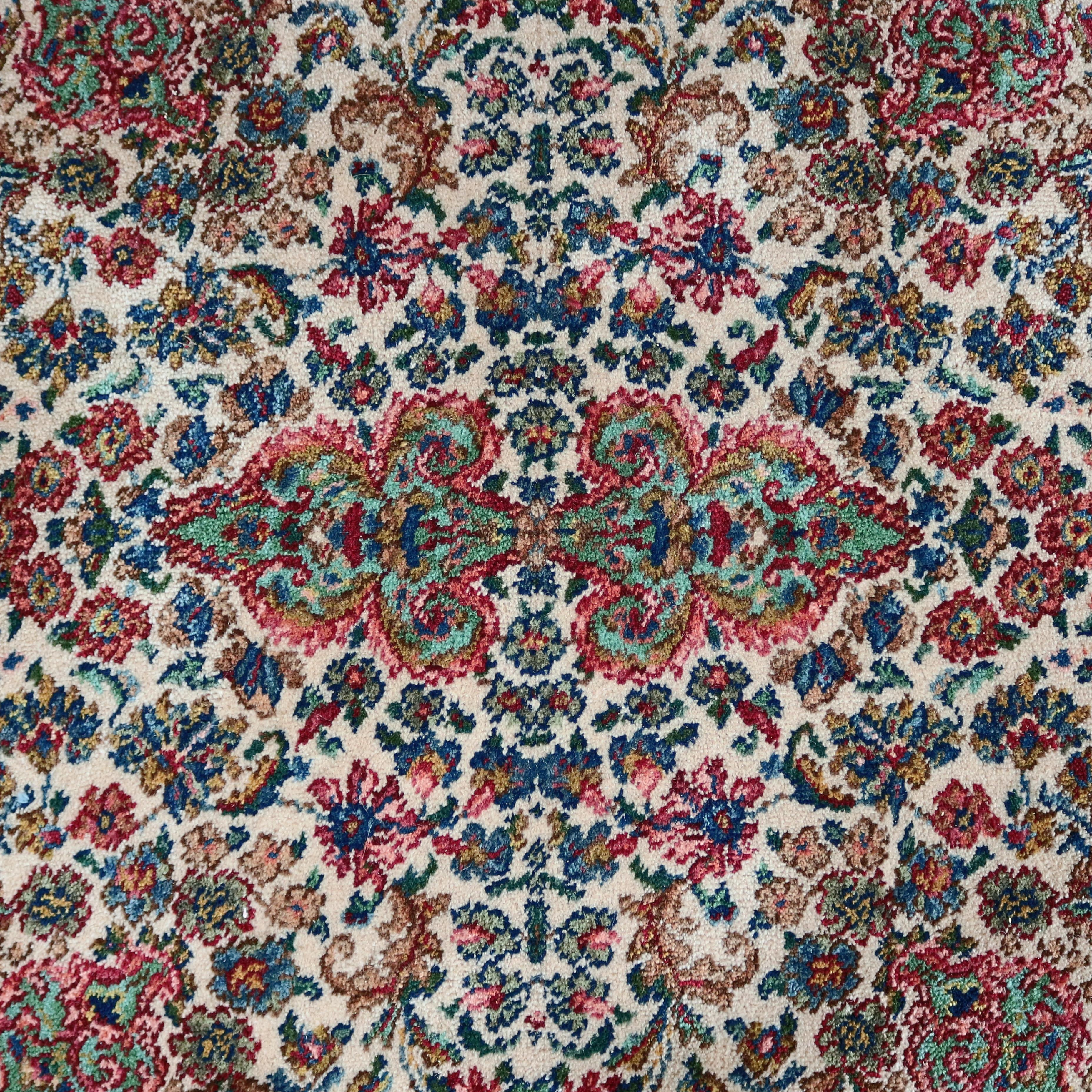A square Kirman style Karastan rug style/pattern #742 features all-over floral pattern on ivory ground, en verso original label, 20th century

Measures - 5' x 5'.