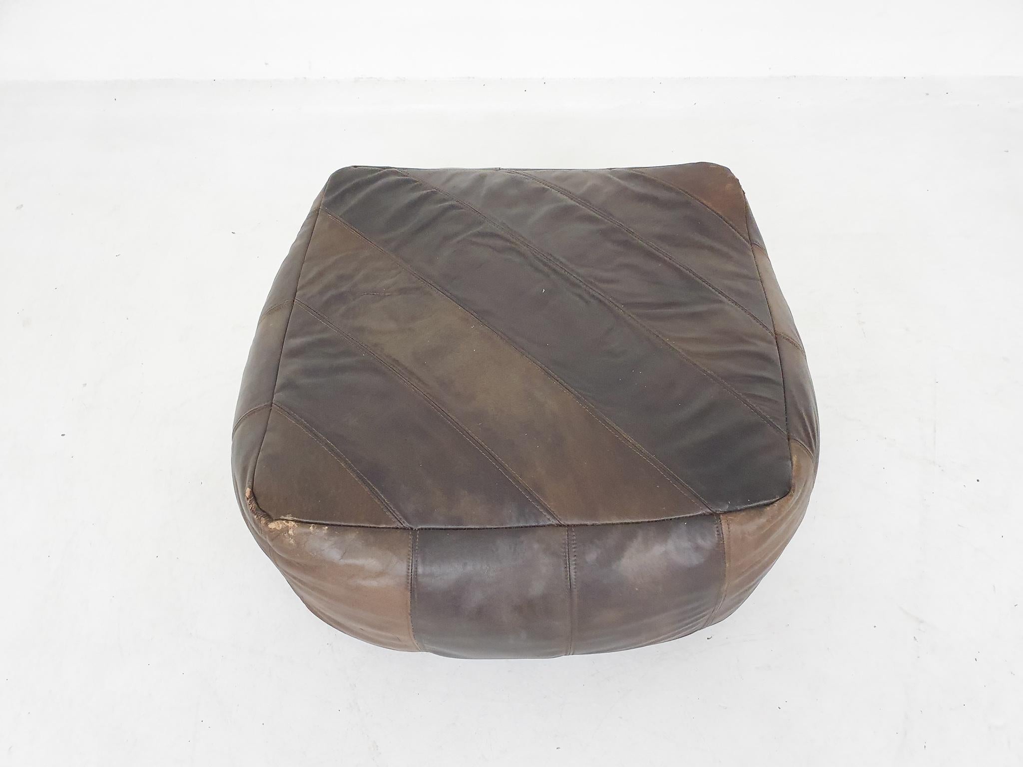 Midcentury brown patchwork leather ottoman.