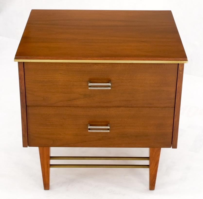 Square light walnut brass stretchers two drawers night stand end table.
Sharp looking brass trim accent light American walnut tapered legs two drawer cabinet.