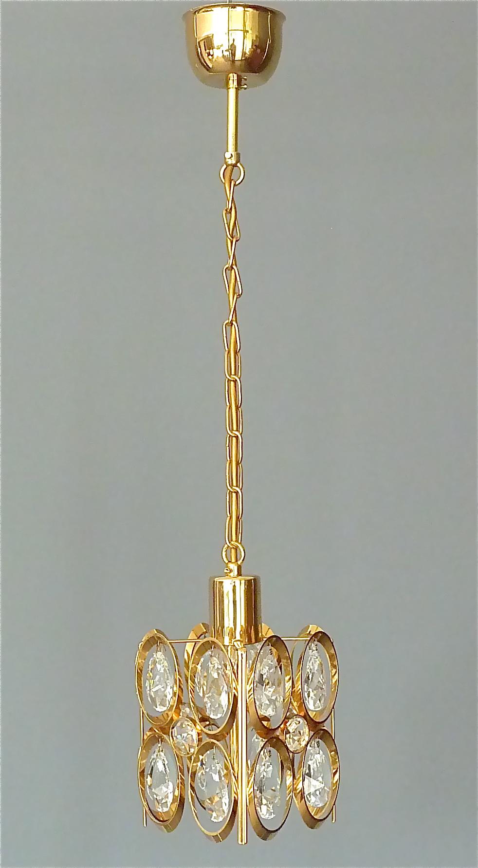 Great gilt brass faceted crystal glass chain hanging pendant lamp made by the famous company Lobmeyr Austria or Palwa Germany, circa 1960. This small but amazing midcentury fixture is made of high quality. It has drop shape and round cut and