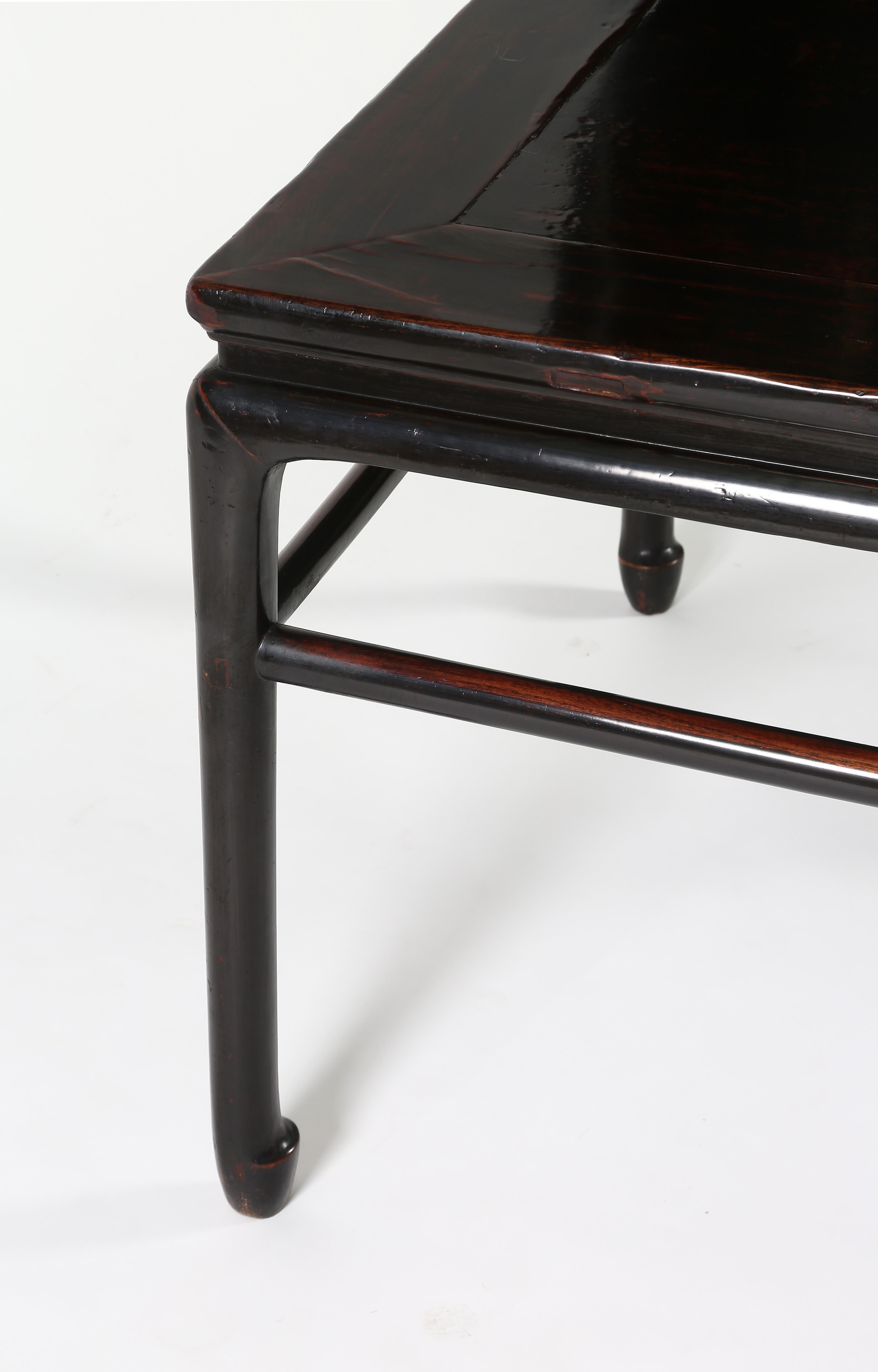 The fine table topped with a floating panel set within an ice-plate edged frame, above a waist, the plain apron extending to form the circular-sectioned legs, braced with straight stretchers and ending in stylized horse hoof feet.
Black lacquer