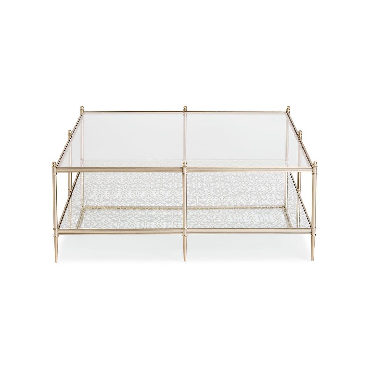 Crafted in a modern mix of materials, its streamlined frame adds a note of luxe in a Neutral metallic finish. A clear glass top reveals a mirrored shelf below, back-painted in a Silver Leaf, mosaic pattern for added dimension.

A clear glass top