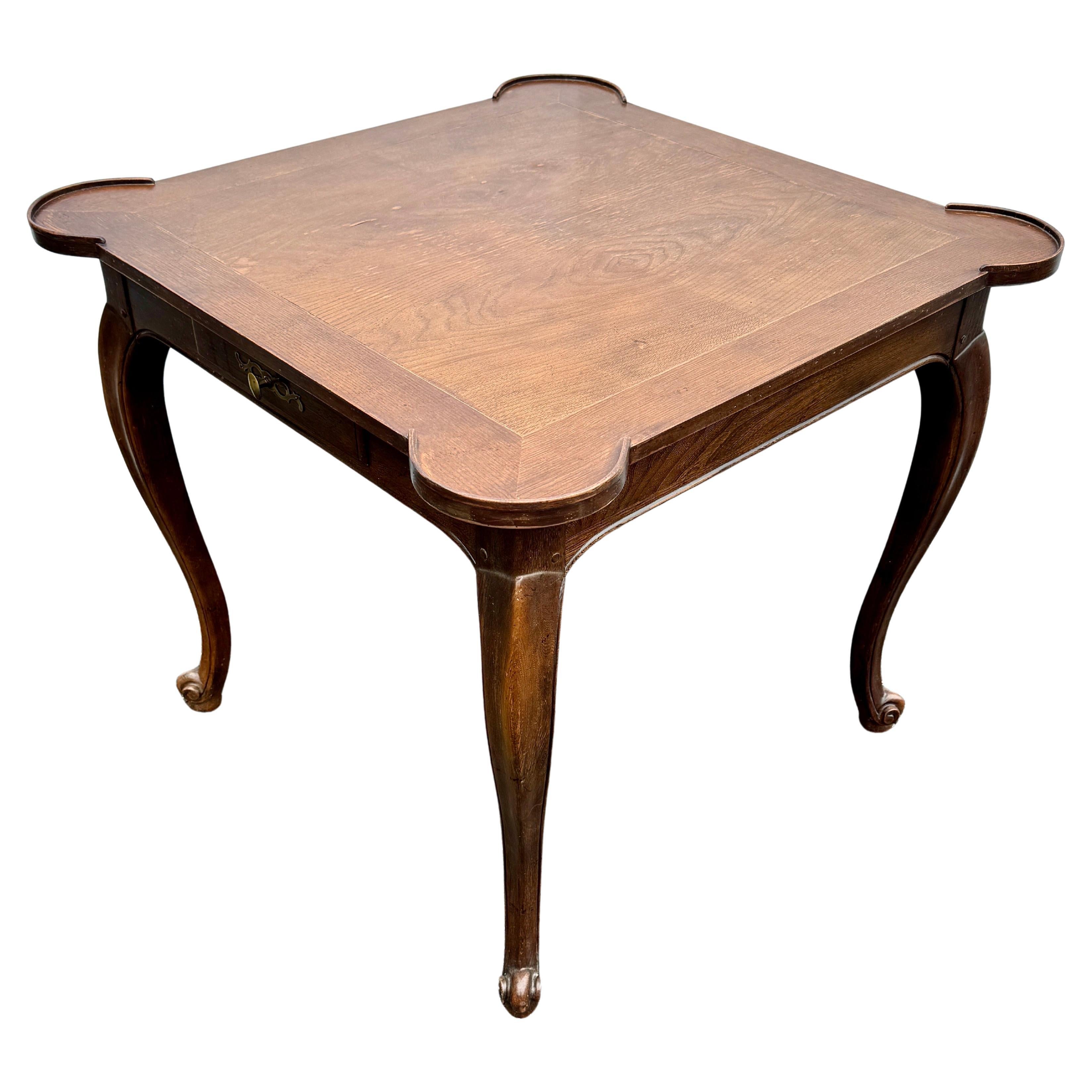 Vintage Square Wood Game Dining Table by The Baker Furniture Company

Classic and versatile game table in its original condition. This one drawer table features rounded corners and cabriole legs. Very solid table that is marked Baker Furniture
