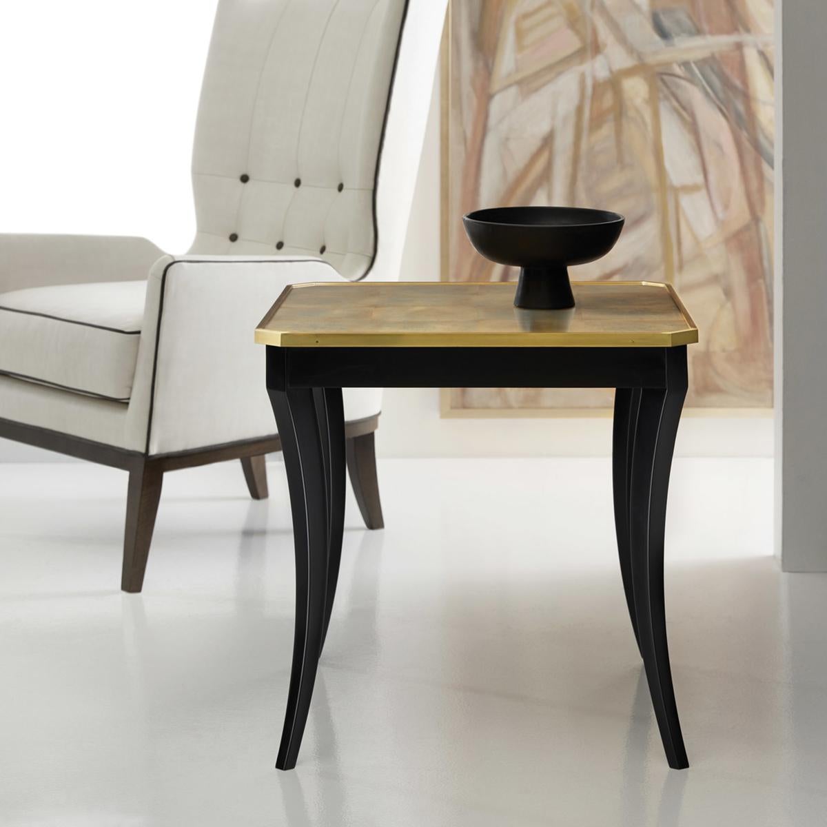 Discover a perfect blend of elegance and functionality with our chic square end table, where classic style meets contemporary flair with our magnificent glass-top golden eglomise finish.

The square gold top with brass trim is beautifully contrasted