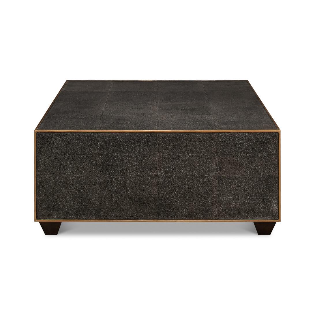 Square Leather Cocktail Table, with grey embossed leather with gold trim raised on simple block feet.

Dimensions: 36