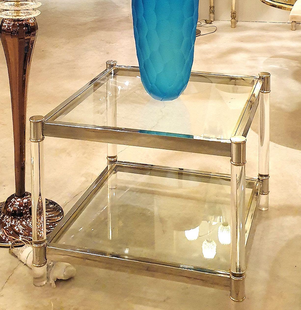 Vintage chrome, lucite and glass square side table with brass accents, attributed to Maison Jansen. France, 1970s.
The coffee table has 2 shelves, in transparent glass: lucite column legs and a two-toned metal finish.
A nice medium size for this