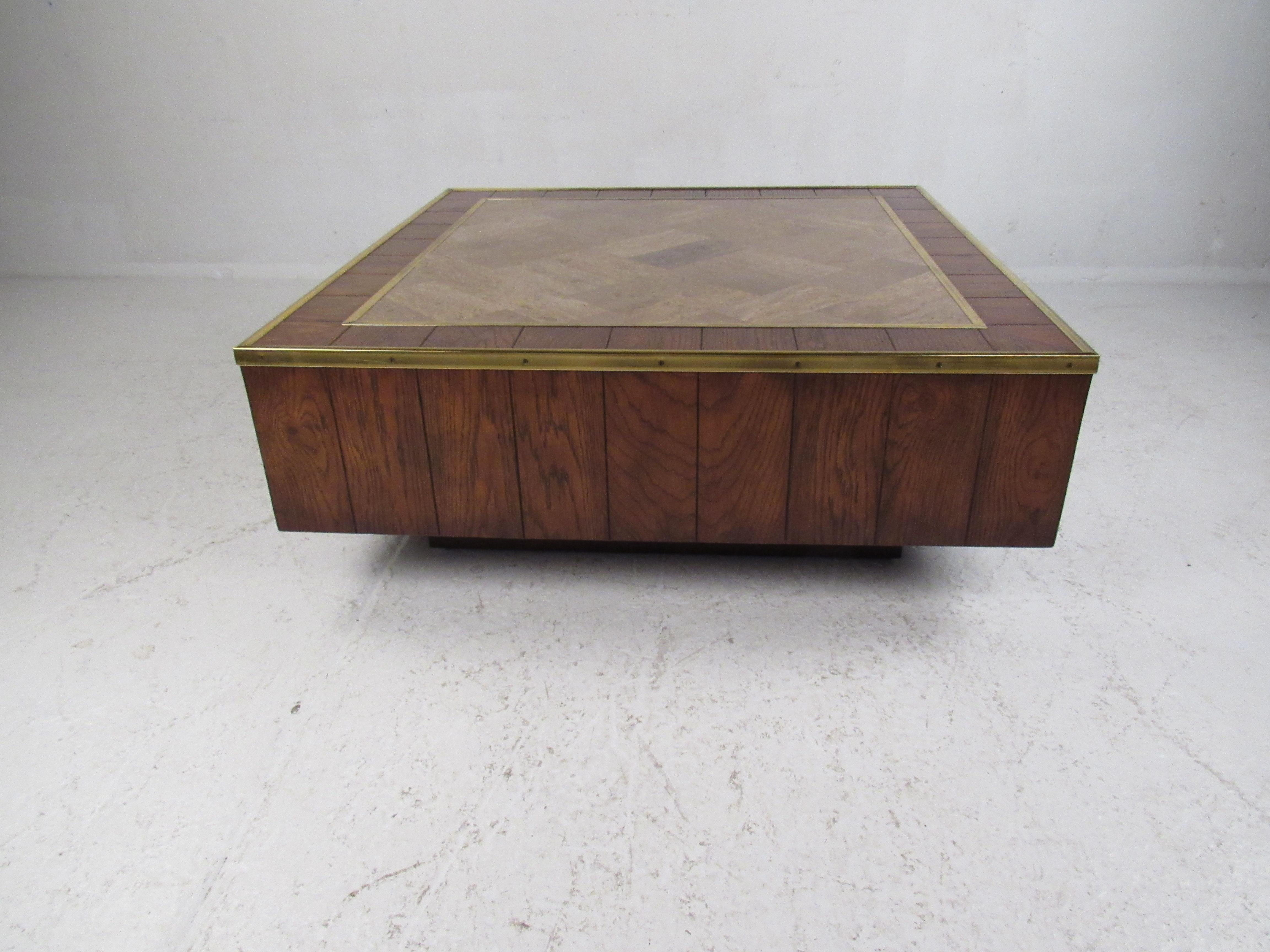 A unique vintage modern coffee table that boasts a tile-top with brass trim. Stylish design with paneled wood and a cubed pedestal base. This unusual Mid-Century Modern coffee table looks amazing in any home, business, or office. Please confirm item