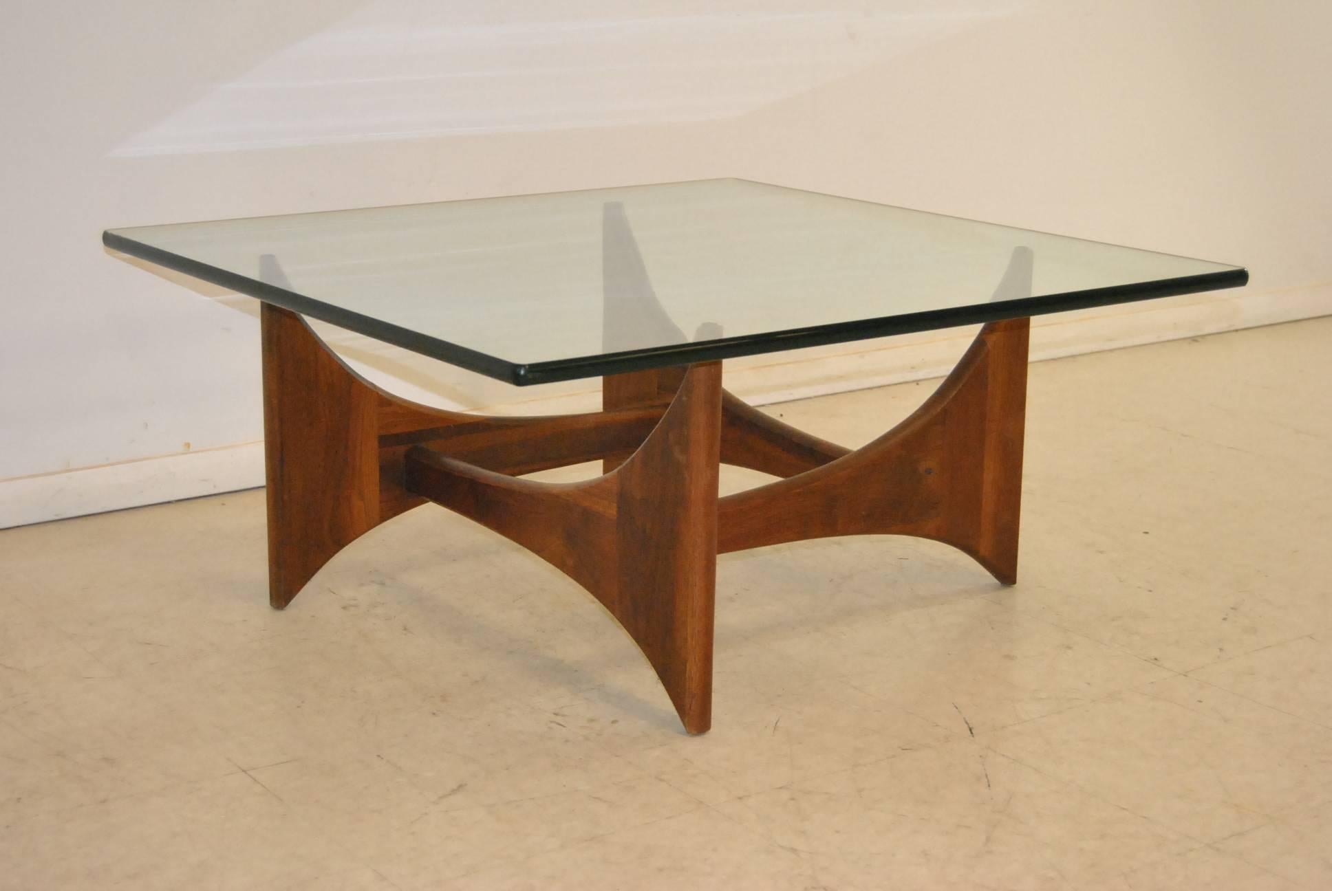 Iconic Mid-Century Modern sculptural coffee or cocktail table of walnut and glass designed by Adrian Pearsall in the 1960s. Its sculptural walnut base, so reminiscent of Noguchi’s style, is still famously Pearsall. The base is comprised of four