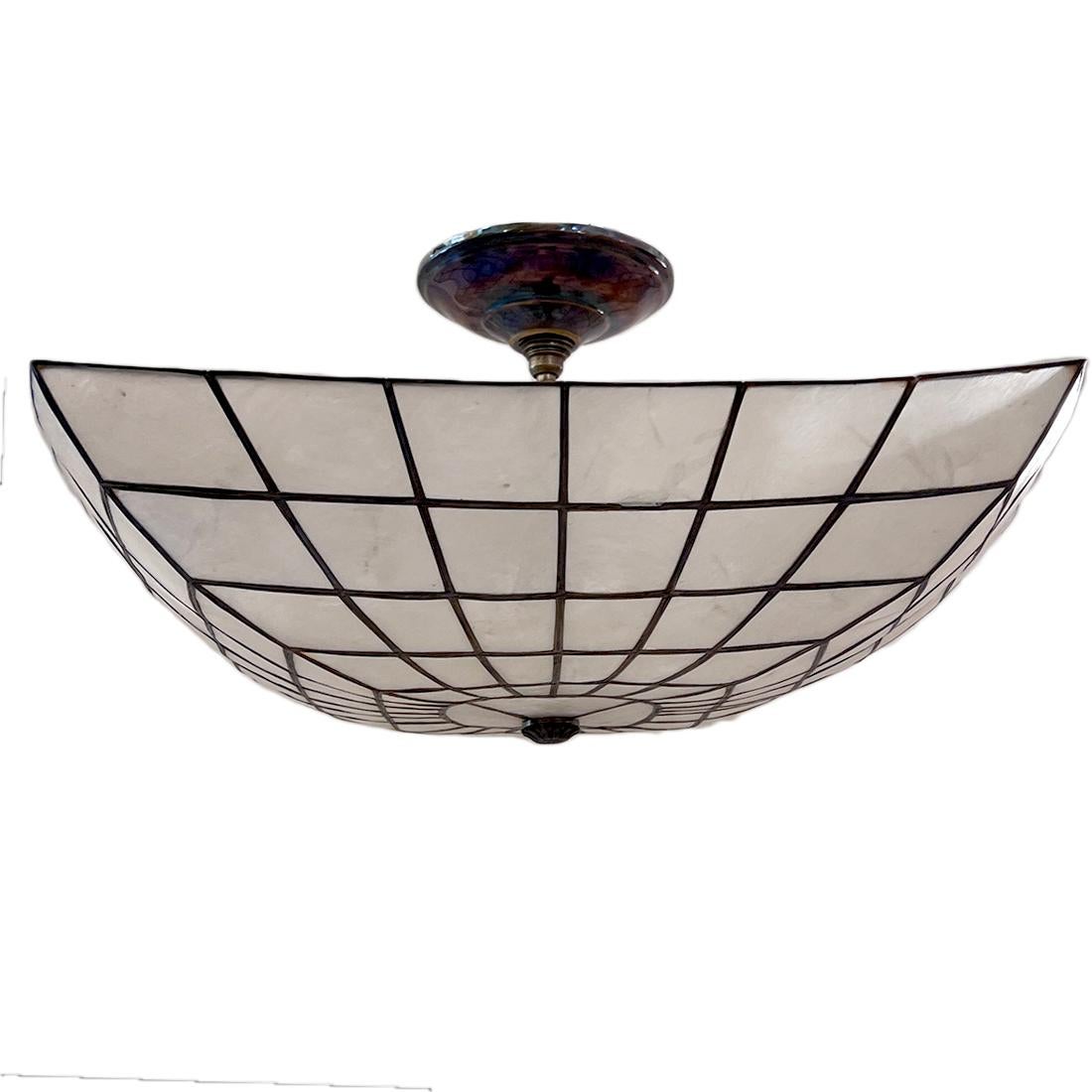 A circa 1950 French capiz light fixture with 4 interior lights.

Measurements:
Drop: 10