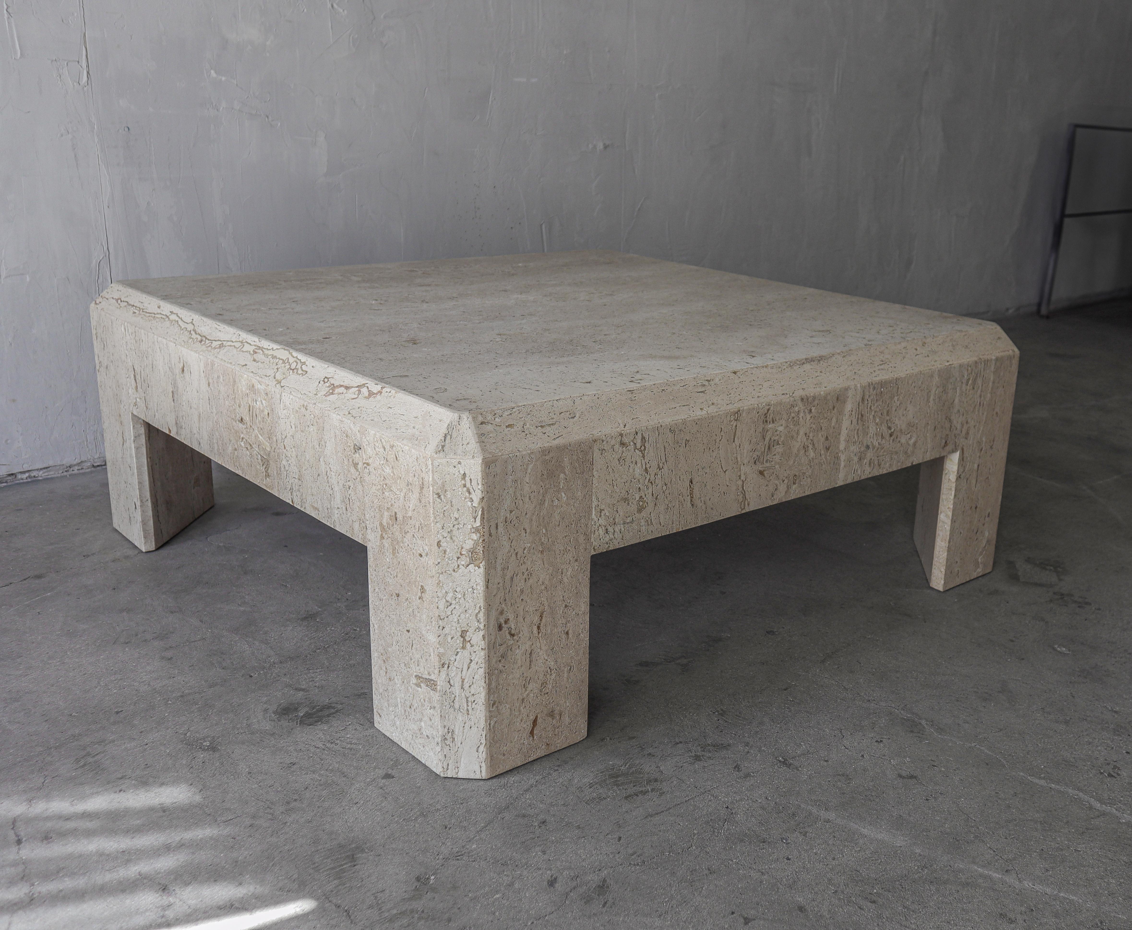 Make a huge statement with this monumental travertine coffee table. Table is very modern, with thick proportions, love the rarely seen angled legs.. This table is the perfect piece if you need minimal yet large coffee table that is stylish while