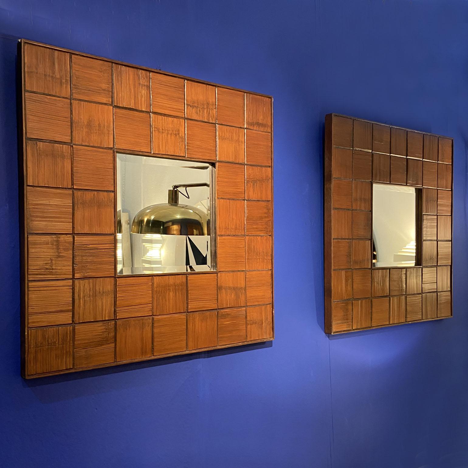 Pair of square mirrors in walnut wood with a decorative border consisting of horizontal and vertical carved square sections of textural squares. The quality square mirror is beveled (dimensions; 29 x 29 cm), made in Italy, 1960s signed GJ.