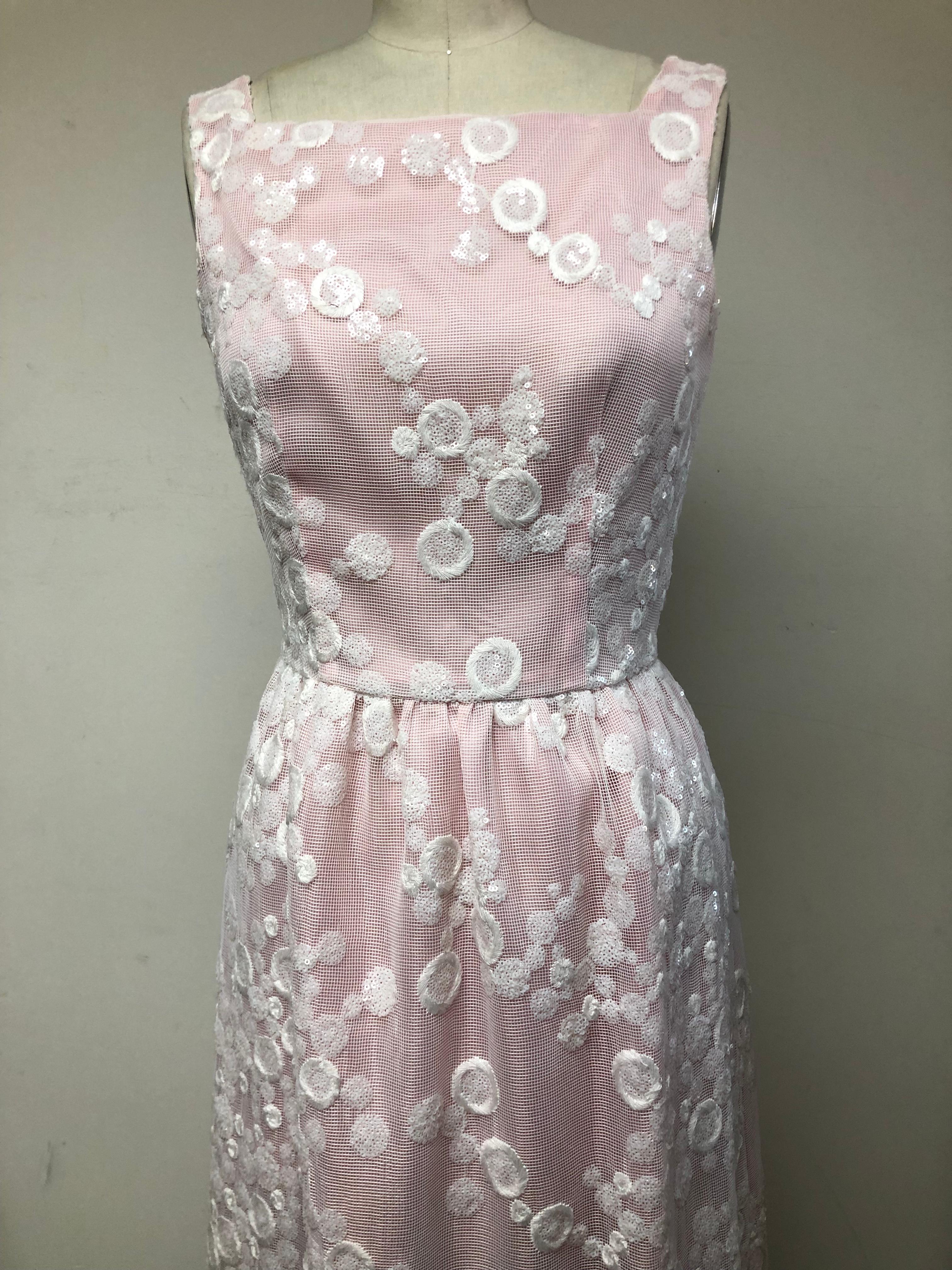 Square Neck Gown with softly gathered skirt lined in the palest pink silk organza overlayed with white mesh embroidery and embellished with sequins. A charming dress perfect for a wedding! The lovely coloration and sparkle go from day into evening.