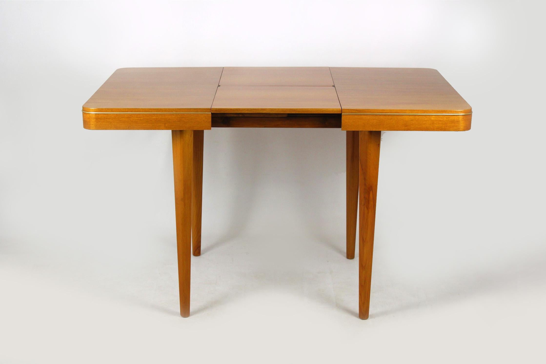 Square, oak veneered folding dining table, manufactured by Jitona in 1960s.
The table measures 125cm wide when fully extended.
Legs can be simply removed for transport or storage.