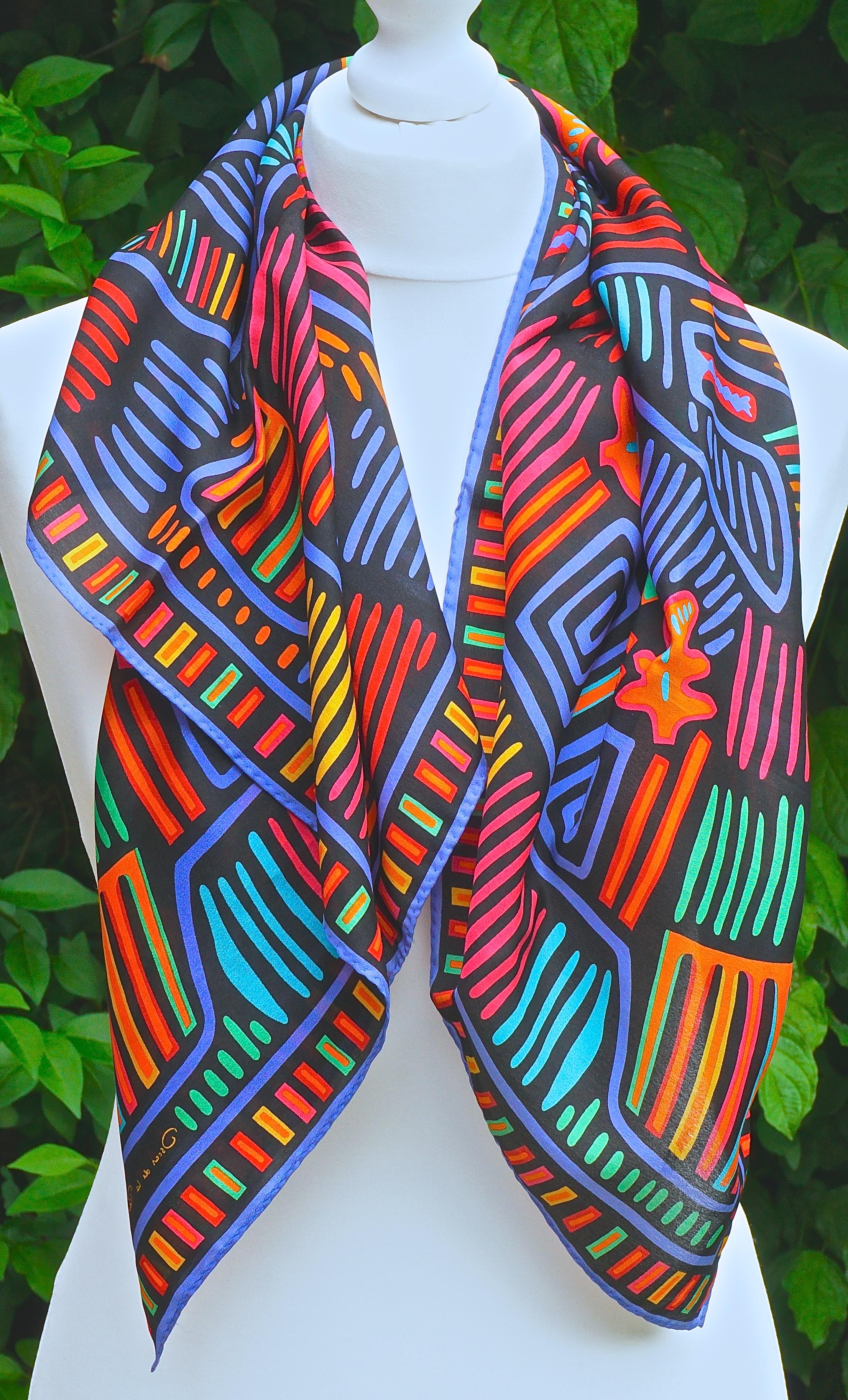 Square Oscar de la Renta for Accessory Street pure silk scarf featuring a lovely multi coloured abstract print on a black background. Measuring approximately 78.74cm / 31 inches square. The scarf is in very good condition, made in Japan.

This