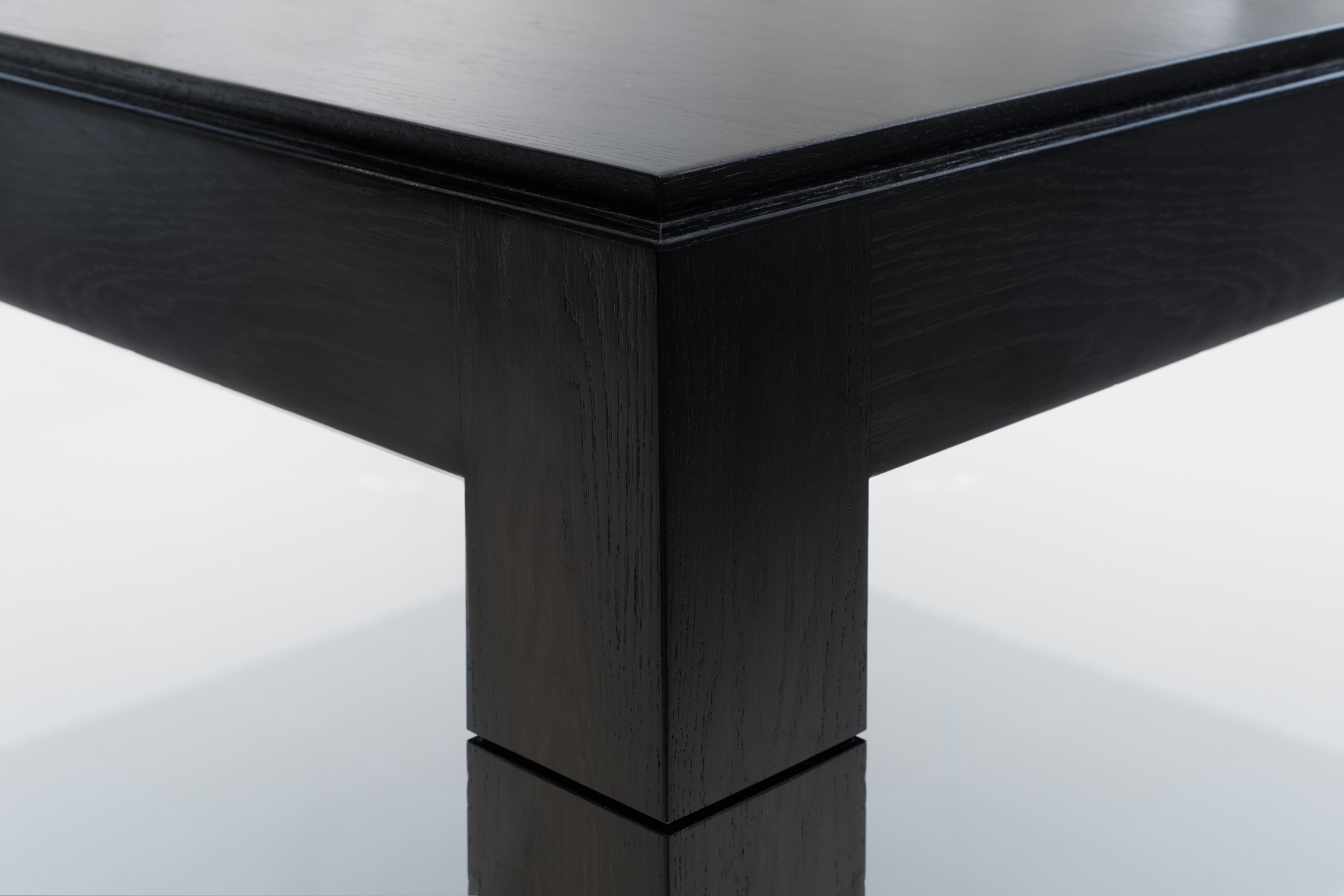Wonderfully proportioned square table with superb quality ebonised and lacquered finish. Quarter-sawn, straight grain solid cherry square with a stepped edge detail along the upper perimeter. 

Suitable for 8 people seated. Beautiful feature inner