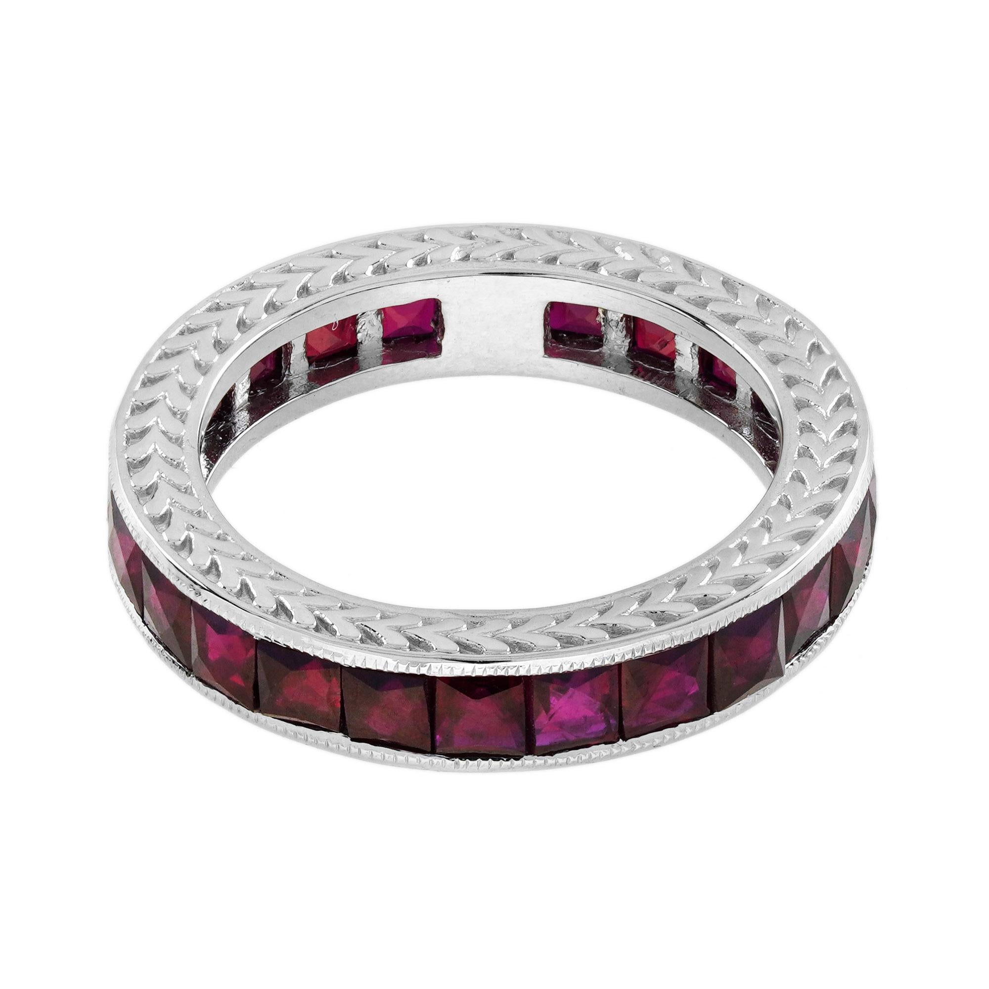 A beautiful ruby eternity band inspired by the Art Deco era. This lovely ring features a row of luscious French cut rubies, which rest in a continuous channel setting. Each delicate ruby displays a vivid red color. This could make a special gemstone