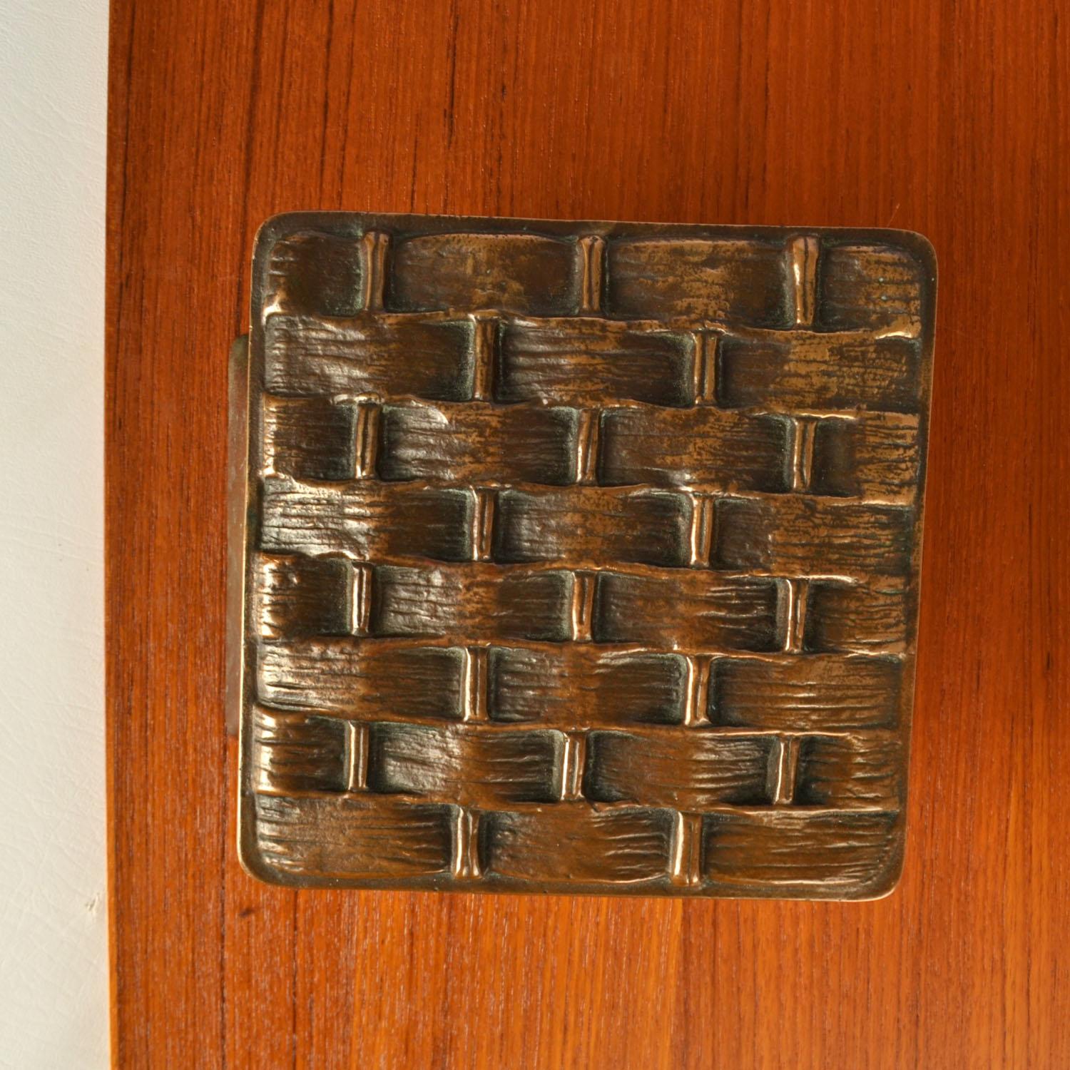 Single square door handle with basket weaving relief. Cast bronze relief in perfect condition. The bronze has a subtitle patina due to the textured surface and its age, circa 1970's. 
Artistic door handle will create personality to any door. The