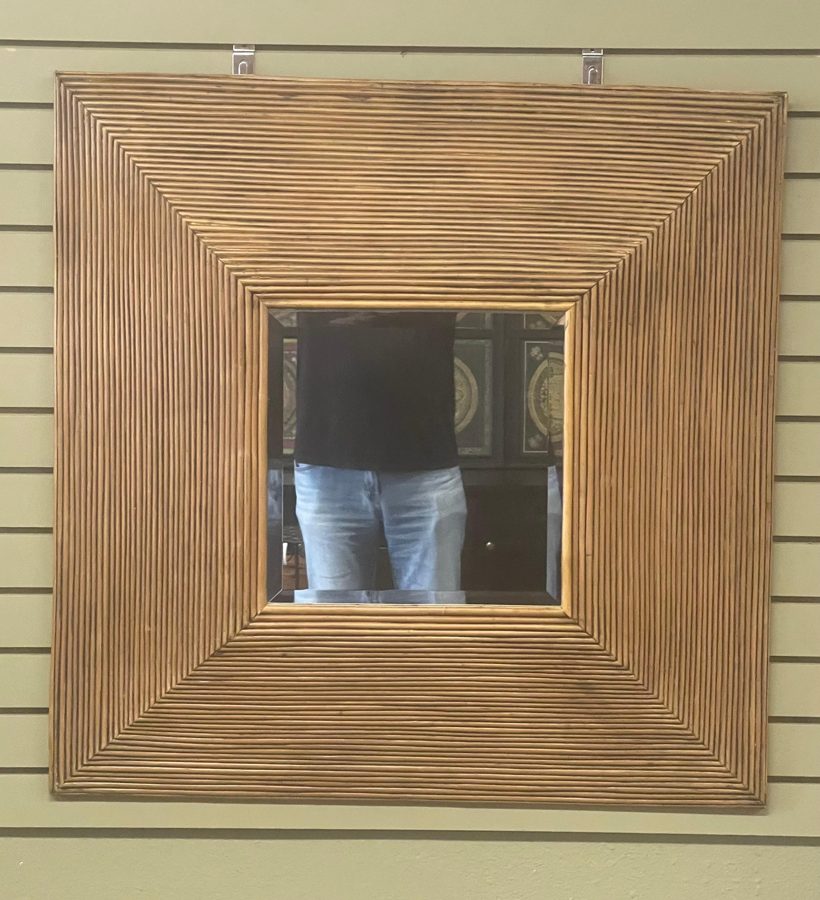 A beautiful square rattan / bamboo elevated mirror, circa 1990s. The mirror is in very good vintage condition and measures 35.25