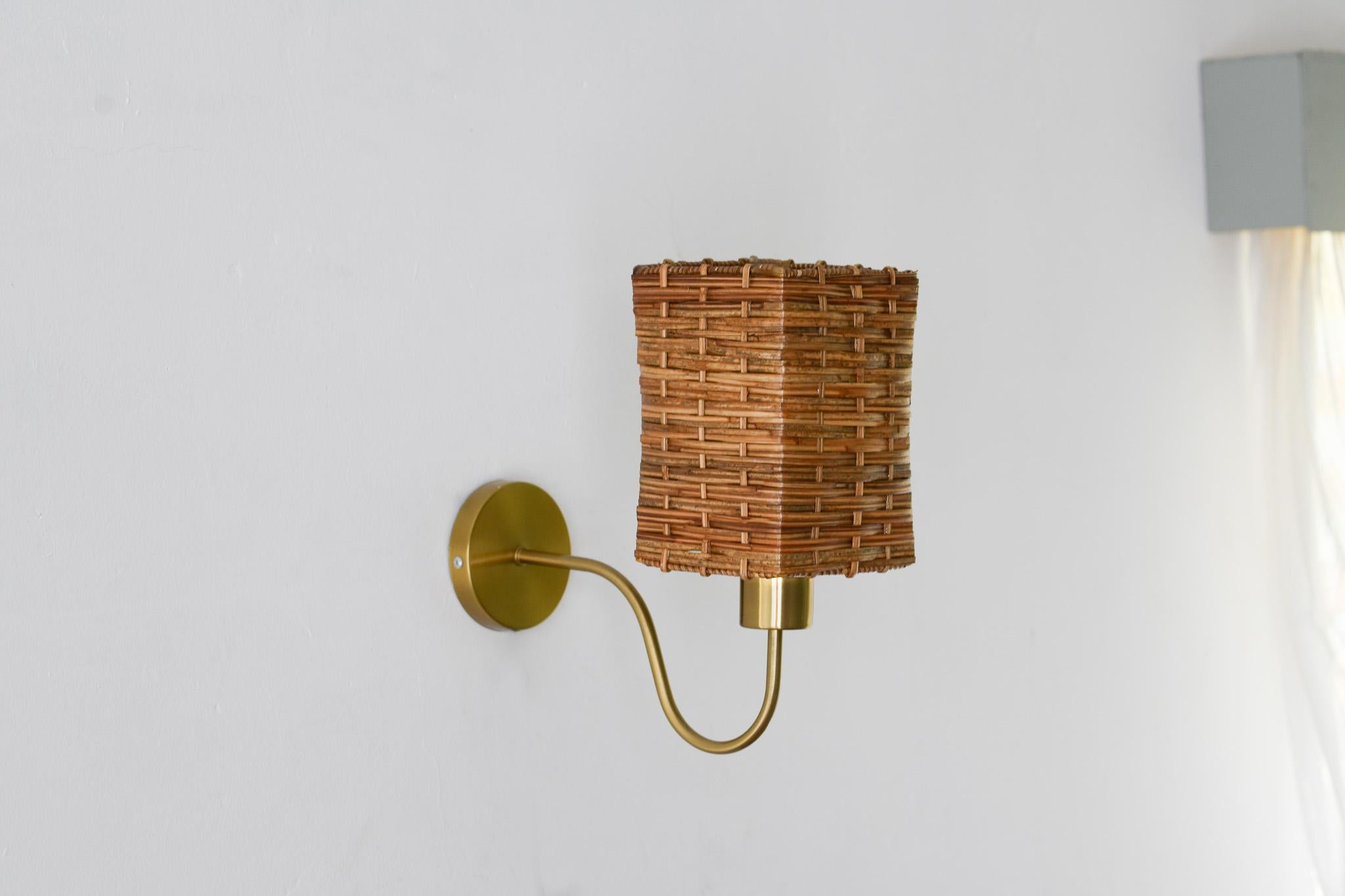 Introducing this handcrafted vintage-style square wicker wall sconce with gold accent. Each piece is uniquely made by local artisans in the Philippines, making it a one-of-a-kind addition to any room. The natural rattan cane gives it an elegant