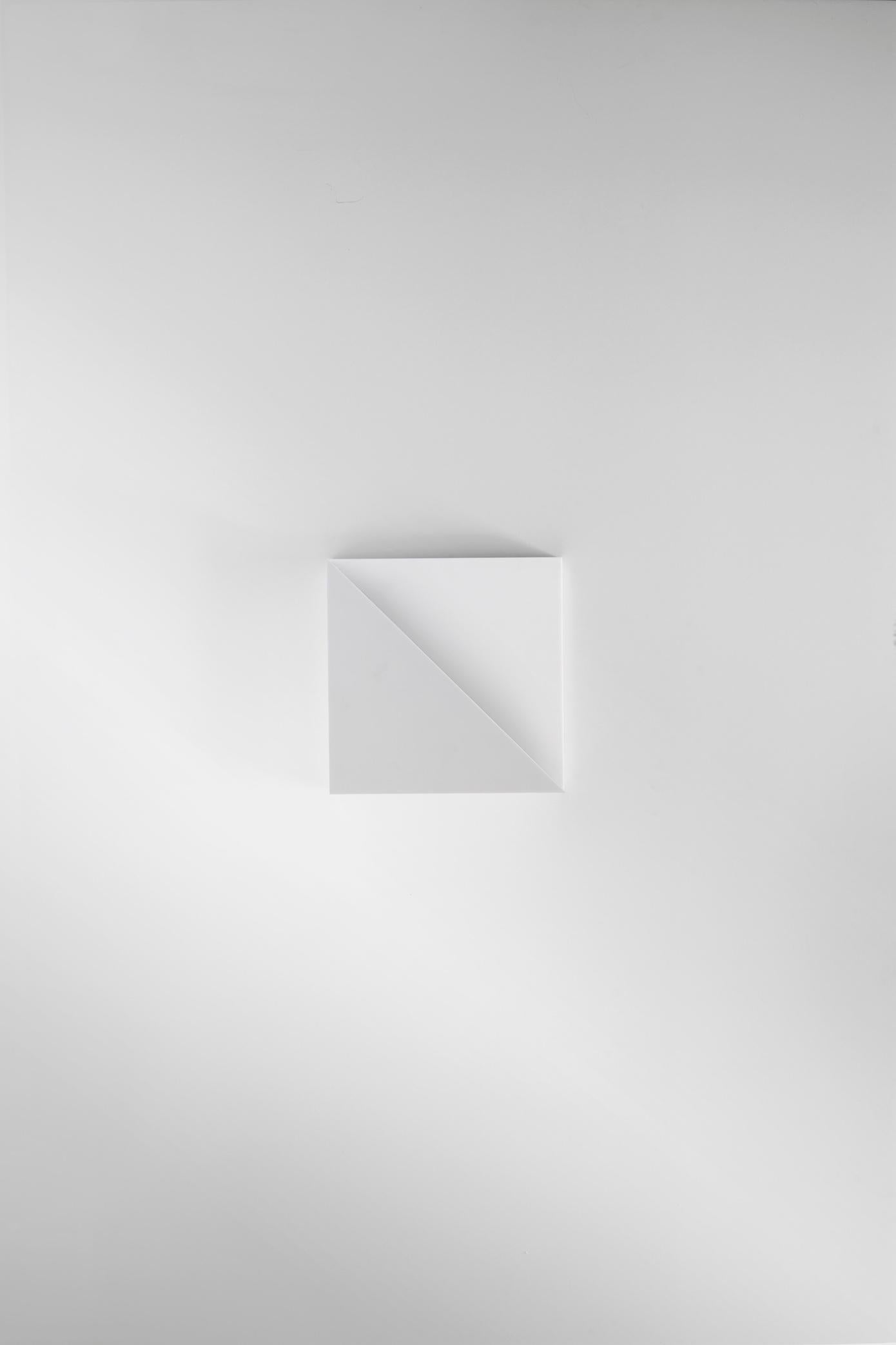Part of the Cycladic Series, exploring the power of architecture brought to small scale. The Square sconce illuminates the purity, symbolism and intimate power of the square and triangle: two of the most emblematic, elemental geometric forms