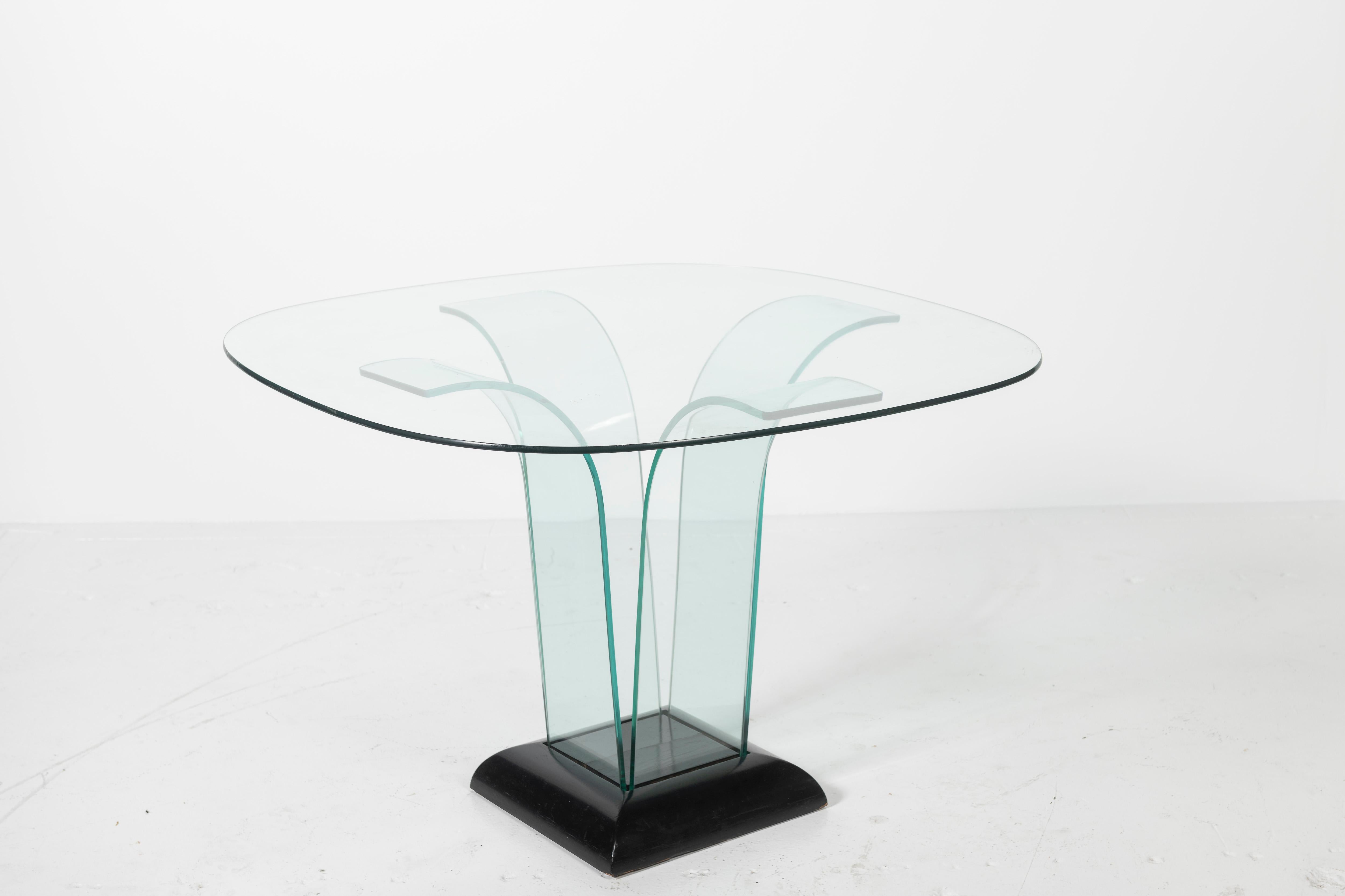 Sculptural center table in rounded rectangular glass with curved glass supports floating in an ebonized wood base by Modernage is a classic. Lovely for an entryway or spacious room.