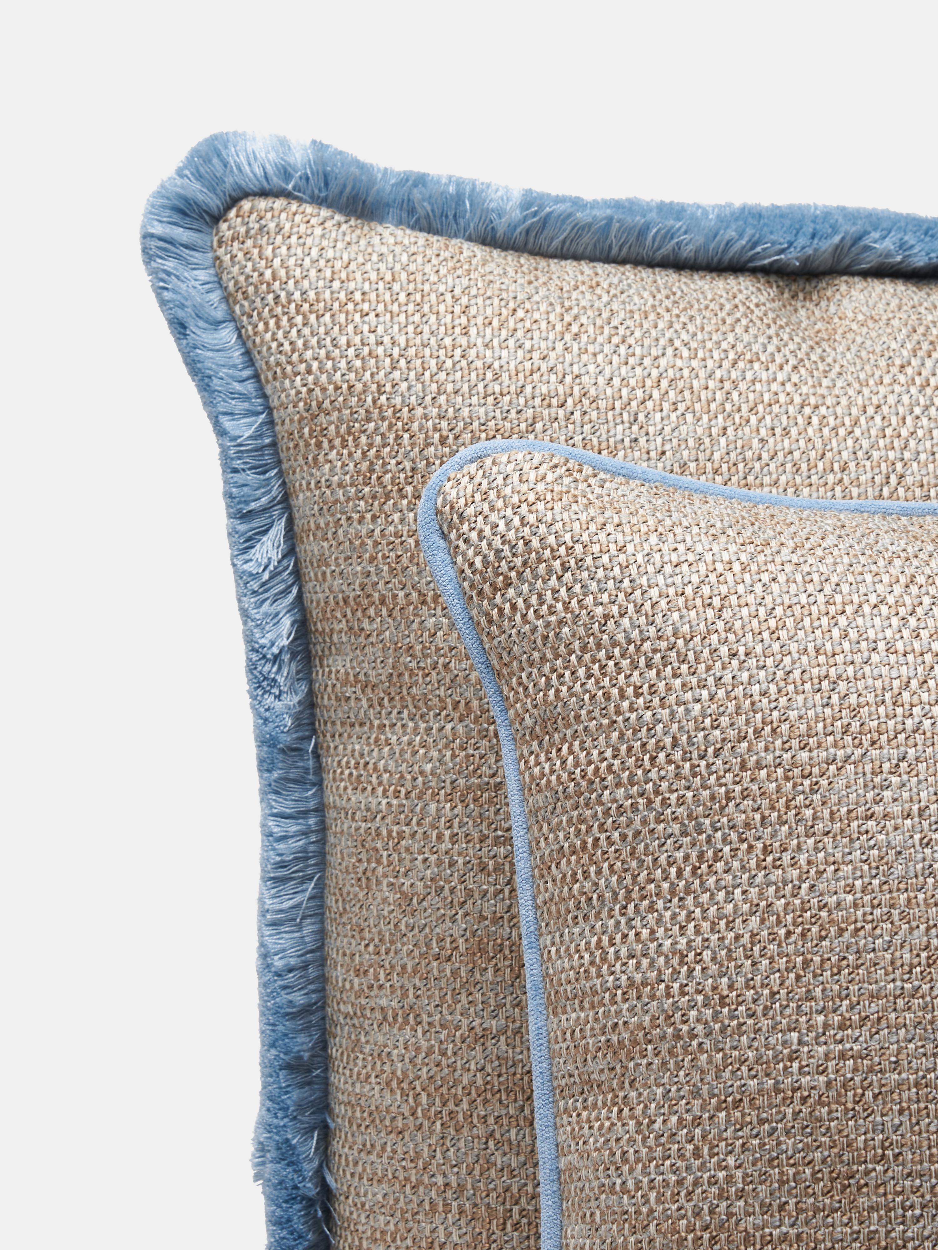 Cuscino quadrato con bordino della linea SERENO di VILLA COMO, realizzato a mano a Como con pregiate stoffe italiane. La sua trama fitta e strutturata esalta la qualità dell'imbottitura, mentre il bordo azzurro aggiunge un dettaglio pulito ed