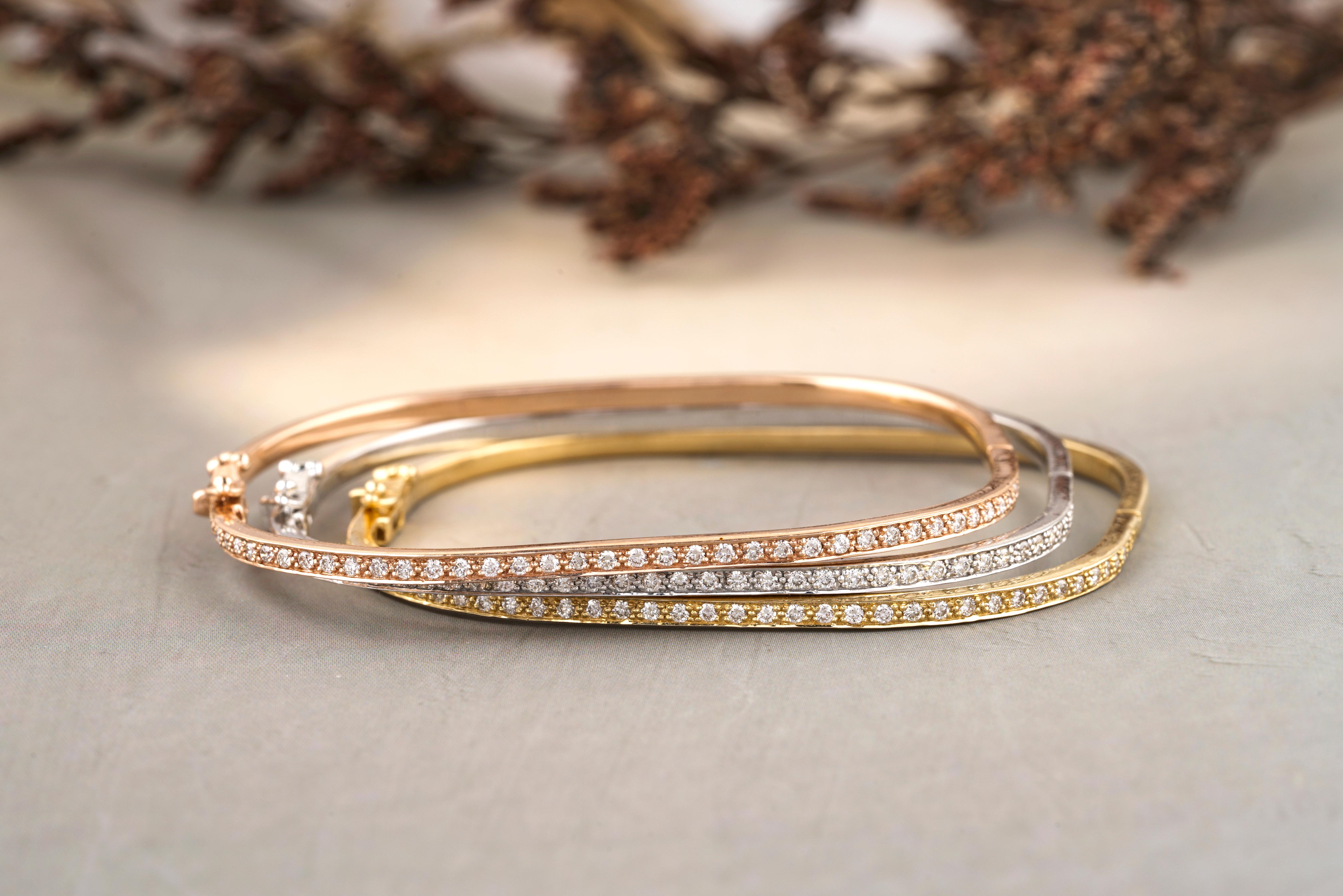 Square Shape Bangle Bracelet meticulously crafted from 18k solid gold. The bangle exhibit a graceful simplicity, featuring a slim design that is both modern and timeless. Bracelet is adorned with a single row of round-cut diamonds, set closely