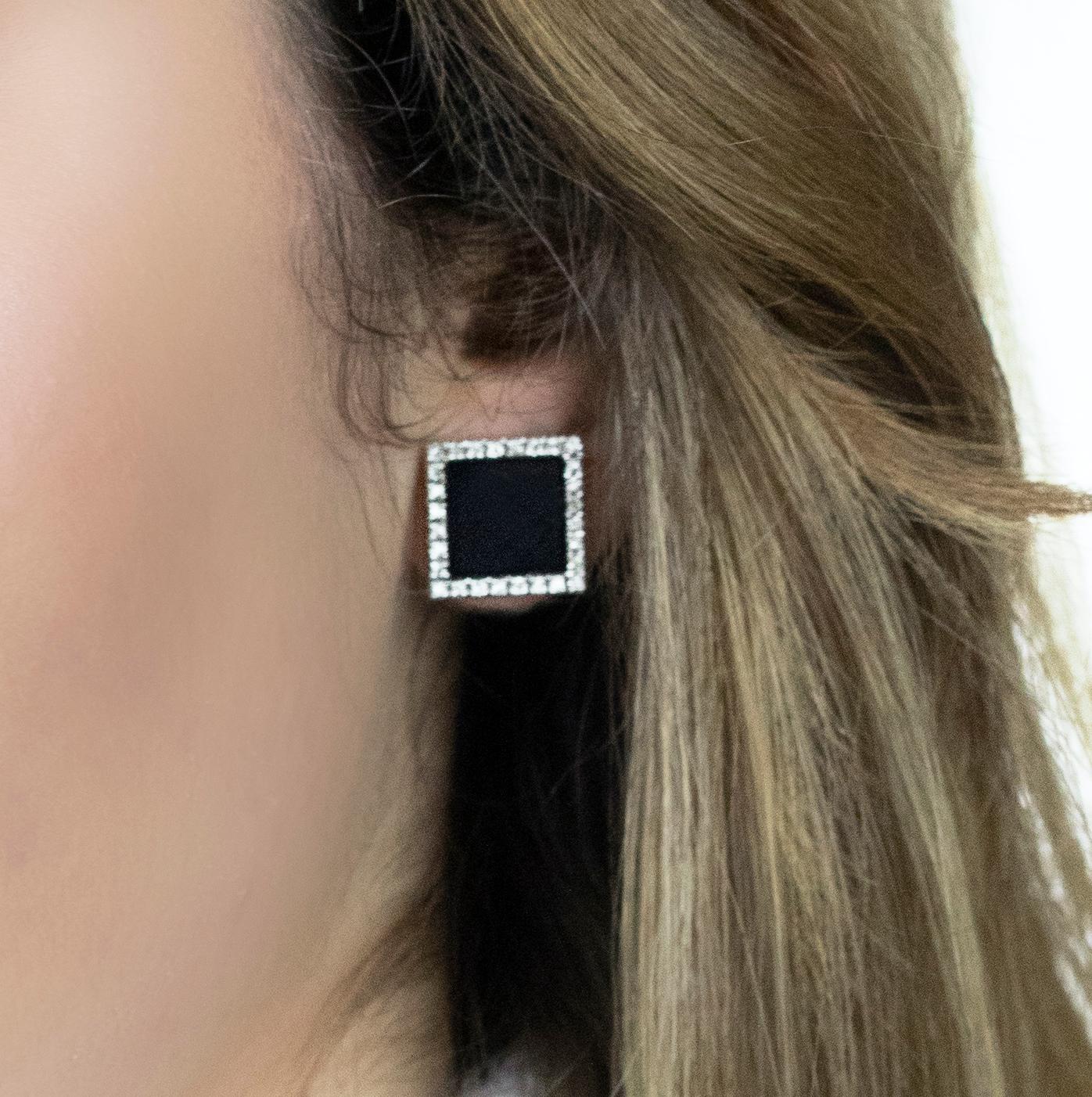 These square onyx earrings, masterfully created by hand from 18K white gold, are set with a border of brilliant white diamonds.

This is a delightful pair of earrings with post and butterfly backs. They measure 13 millimetres across. 

Looking for a