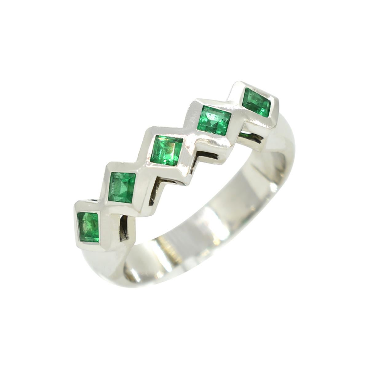 18K white gold emerald wedding band ring with a beautiful selection of 5 square cut natural Colombian emeralds in 0.37 carats total weight with a stunning medium dark green tone, good clarity, and excellent brilliance.

The emeralds are set in