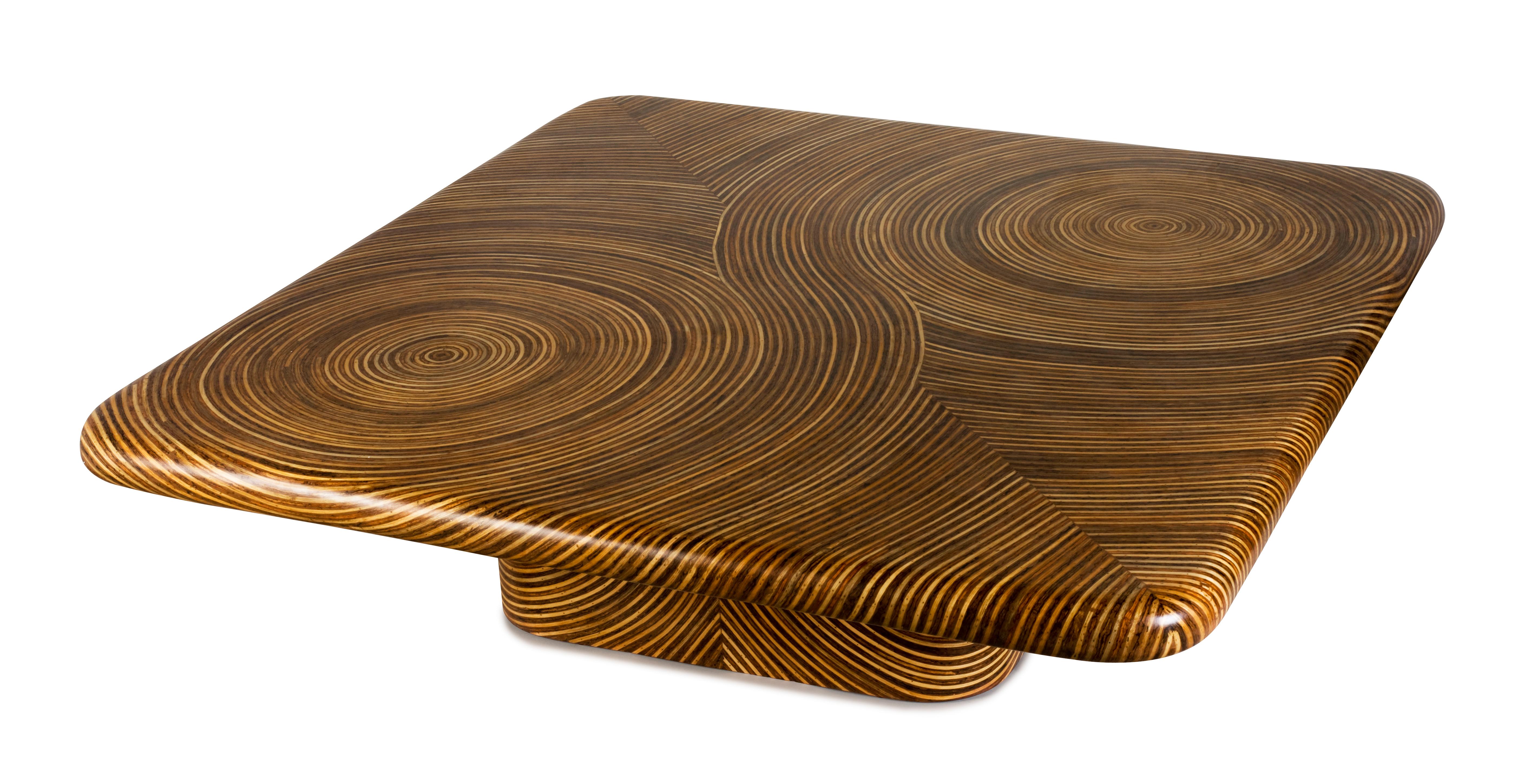 Swirling patterns are crafted through the artful inlay of rattan ribbons. The captivating 