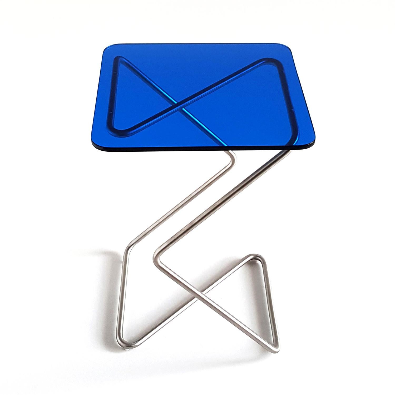 The square side table by Rita Kettaneh
Dimensions: The base: Brushed stainless steel 
 optionally plated with copper or brass
 The top: acrylic
Materials: H 46 x W 33 x D 33 cm
Weight: 3.75 Kg

Colors and finishes:
Stainless finish: Burnt