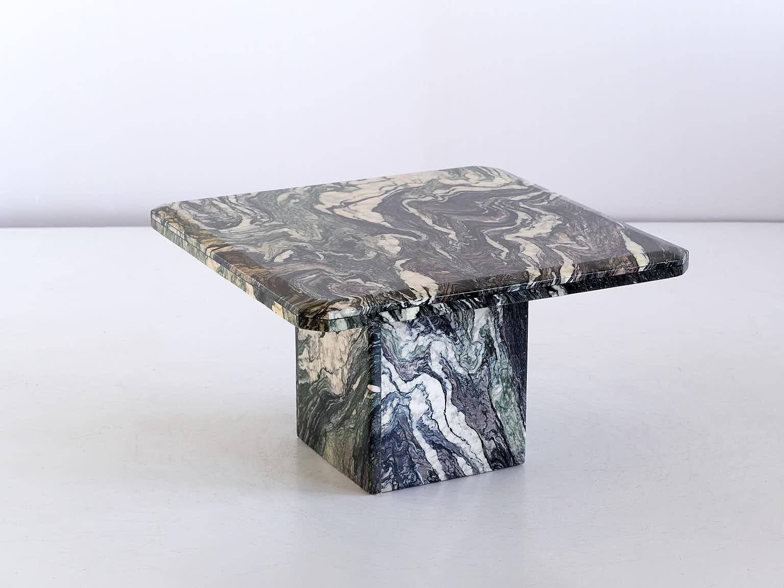 This striking side / end table was produced in Italy in the 1970s. The square top and square base are both made of Cipollino marble. This rare marble has a beautiful wavy pattern composed of different hues and intensities of green, grey and white