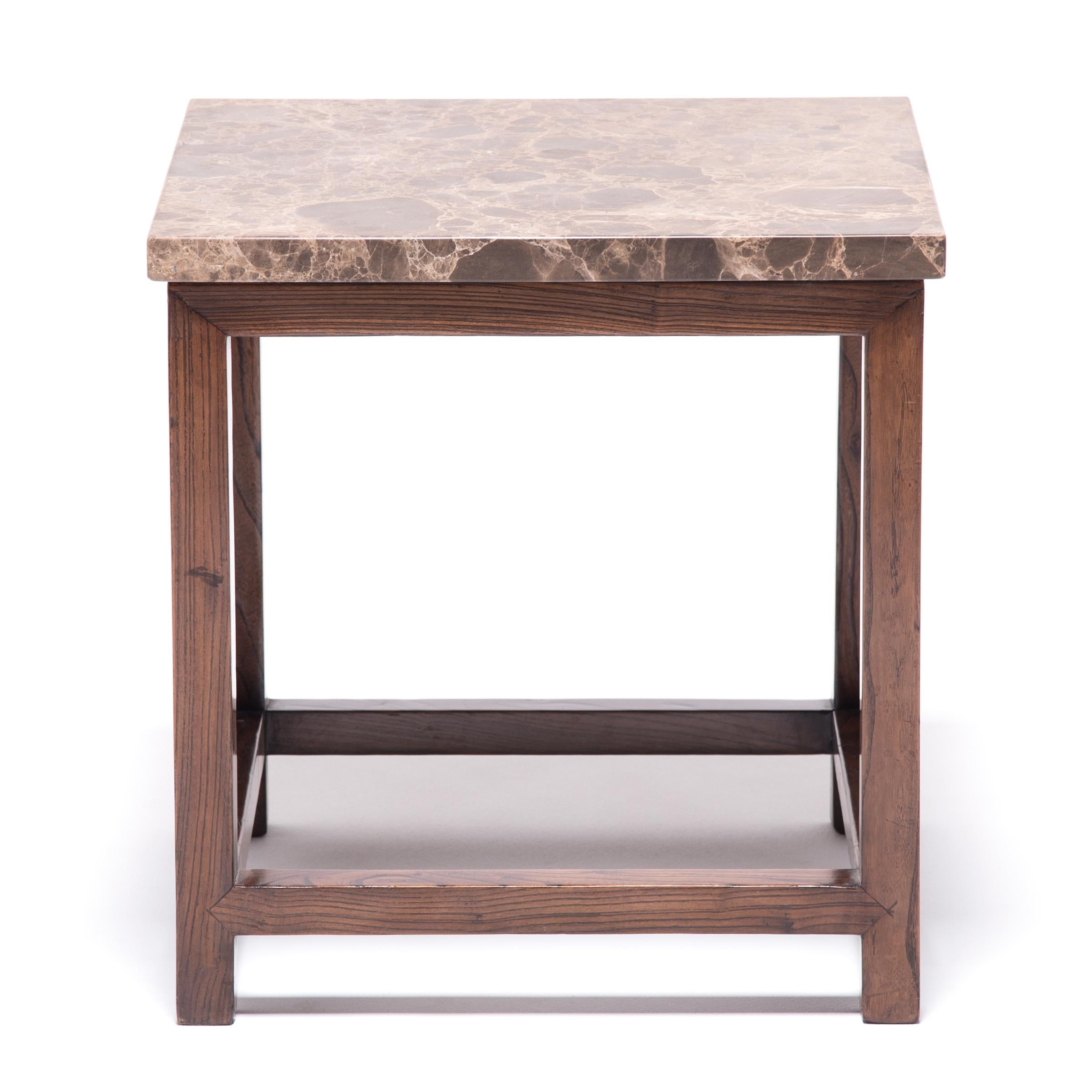 This deceptively simple feng deng (square stool) is a masterpiece of the harmonious design celebrated in traditional Chinese furniture. Clear in construction and pure in materials, the stool is a great example of corner-leg furniture, a box-like