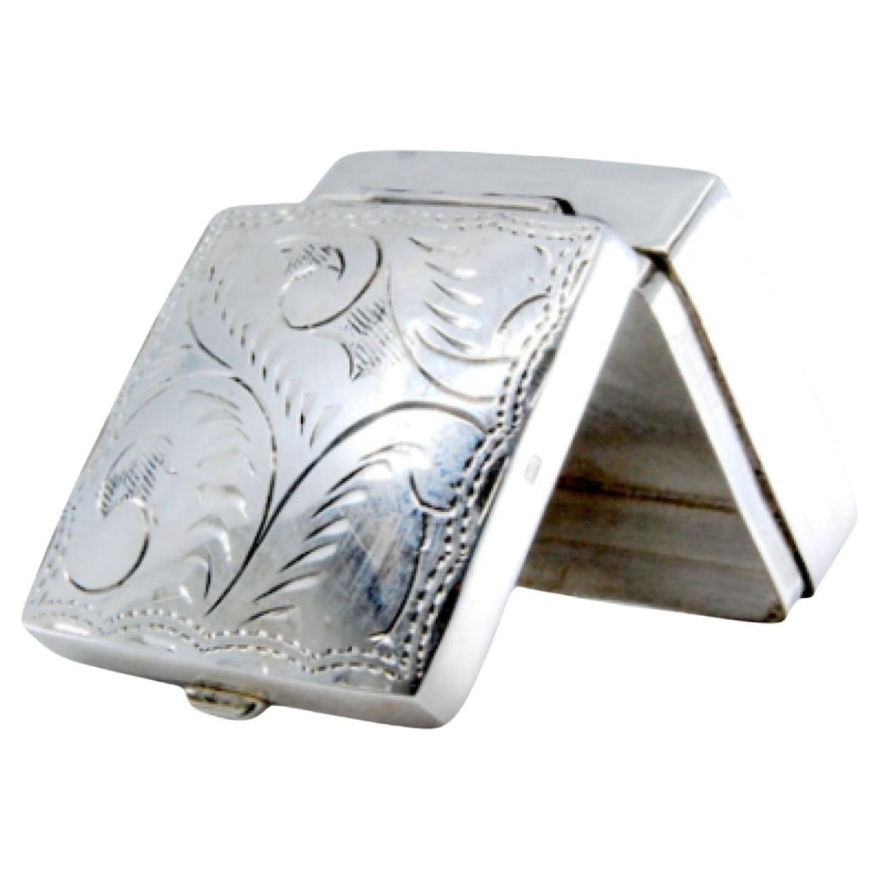 Square silver pill box with plant motifs engraved on the hinged lid